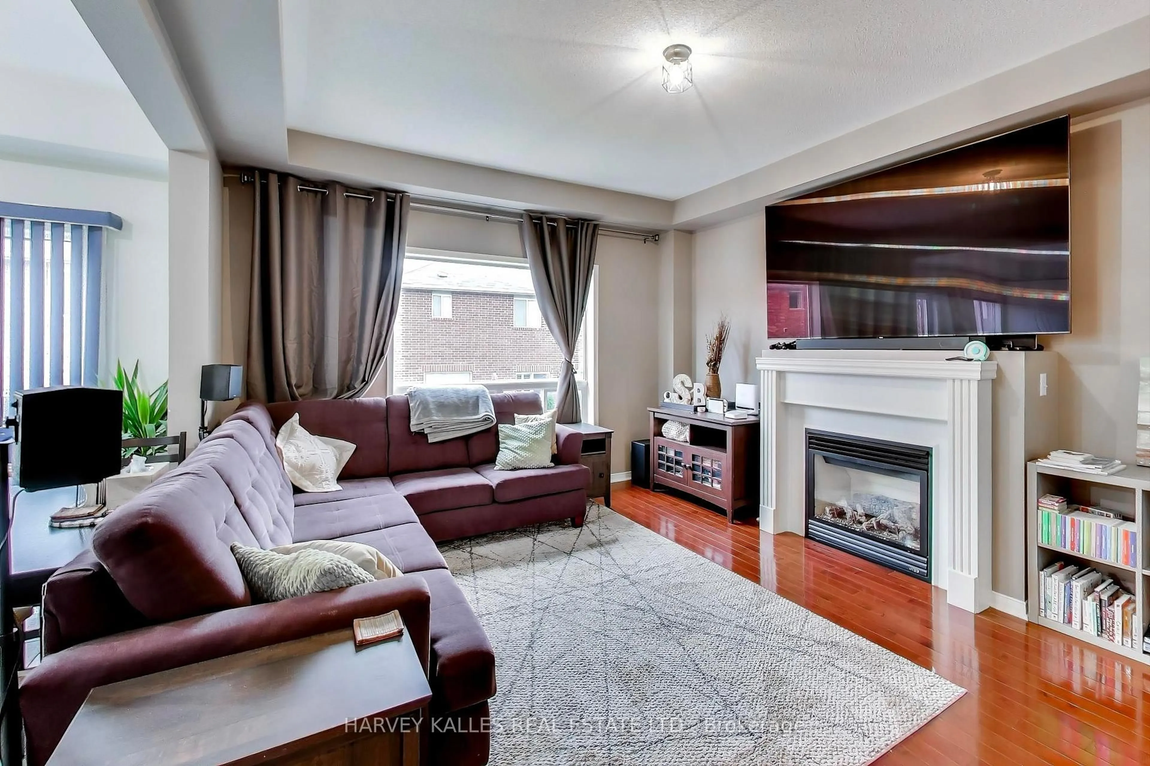 Living room with furniture, wood/laminate floor for 136 Degrassi Cove Circ, Brampton Ontario L6X 0N8