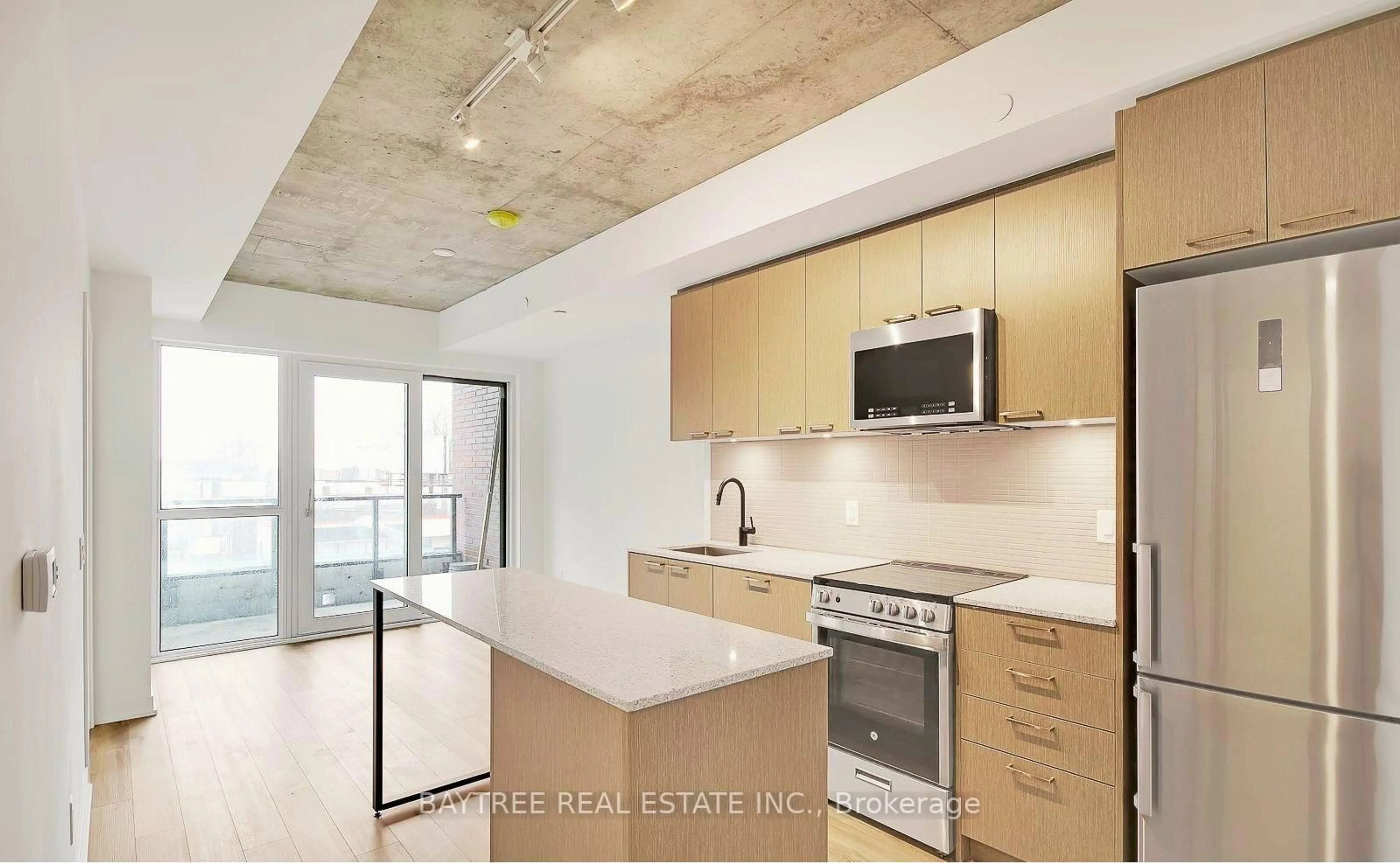 Open concept kitchen, cement floor for 1808 St Clair Ave #510, Toronto Ontario M6N 0C1