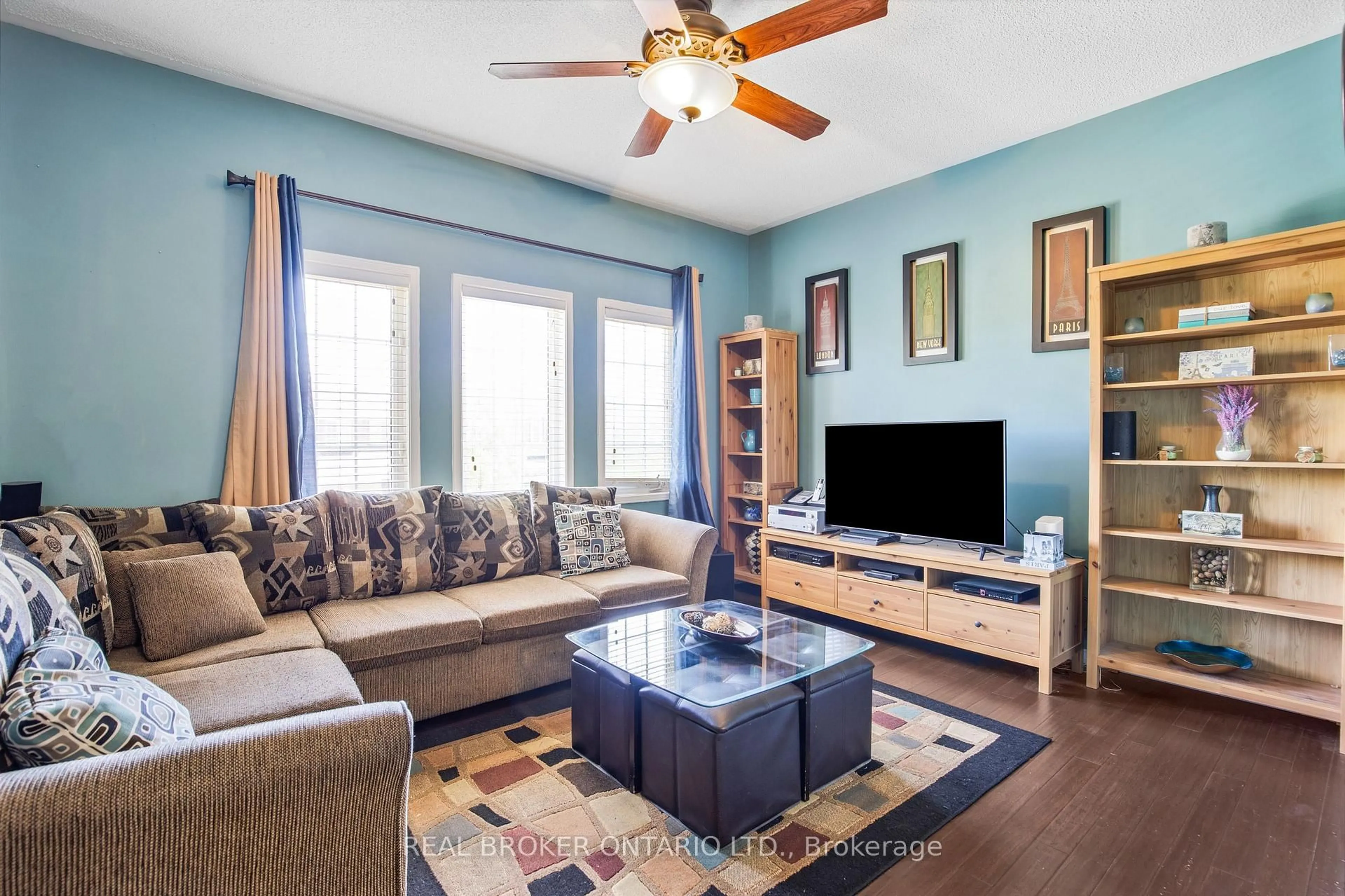 Living room with furniture, wood/laminate floor for 56 Lockheed Cres, Brampton Ontario L7A 3G4