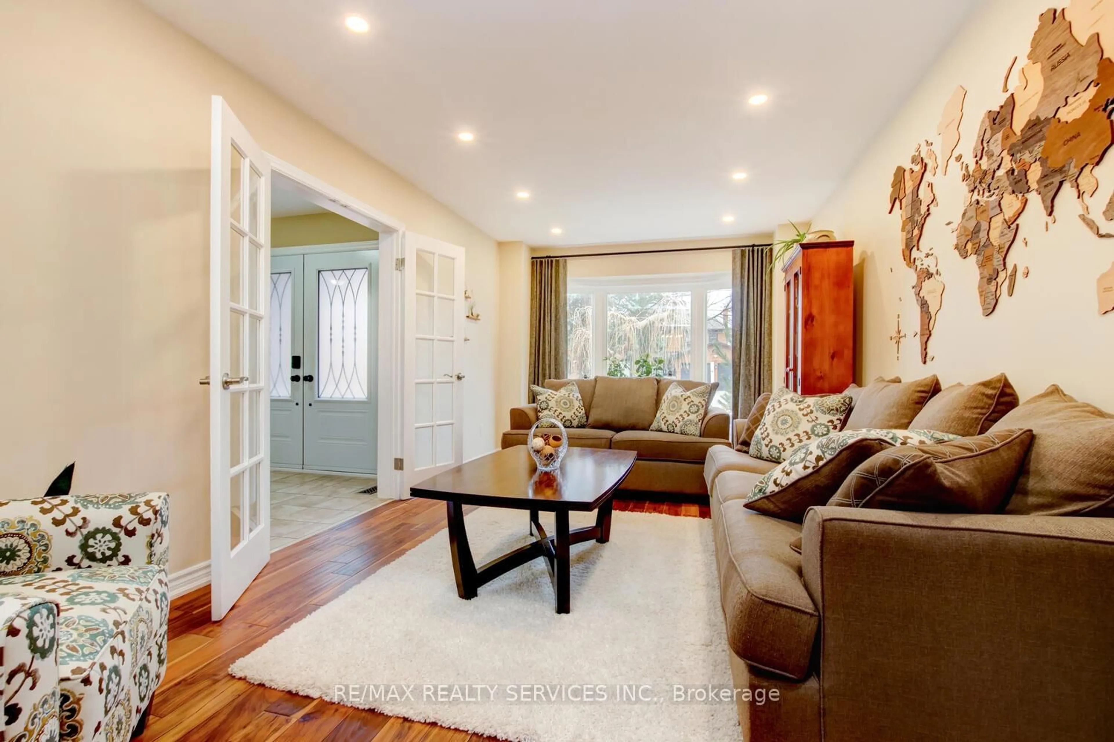 Living room with furniture, wood/laminate floor for 28 Chickadee Cres, Brampton Ontario L6Z 3L2