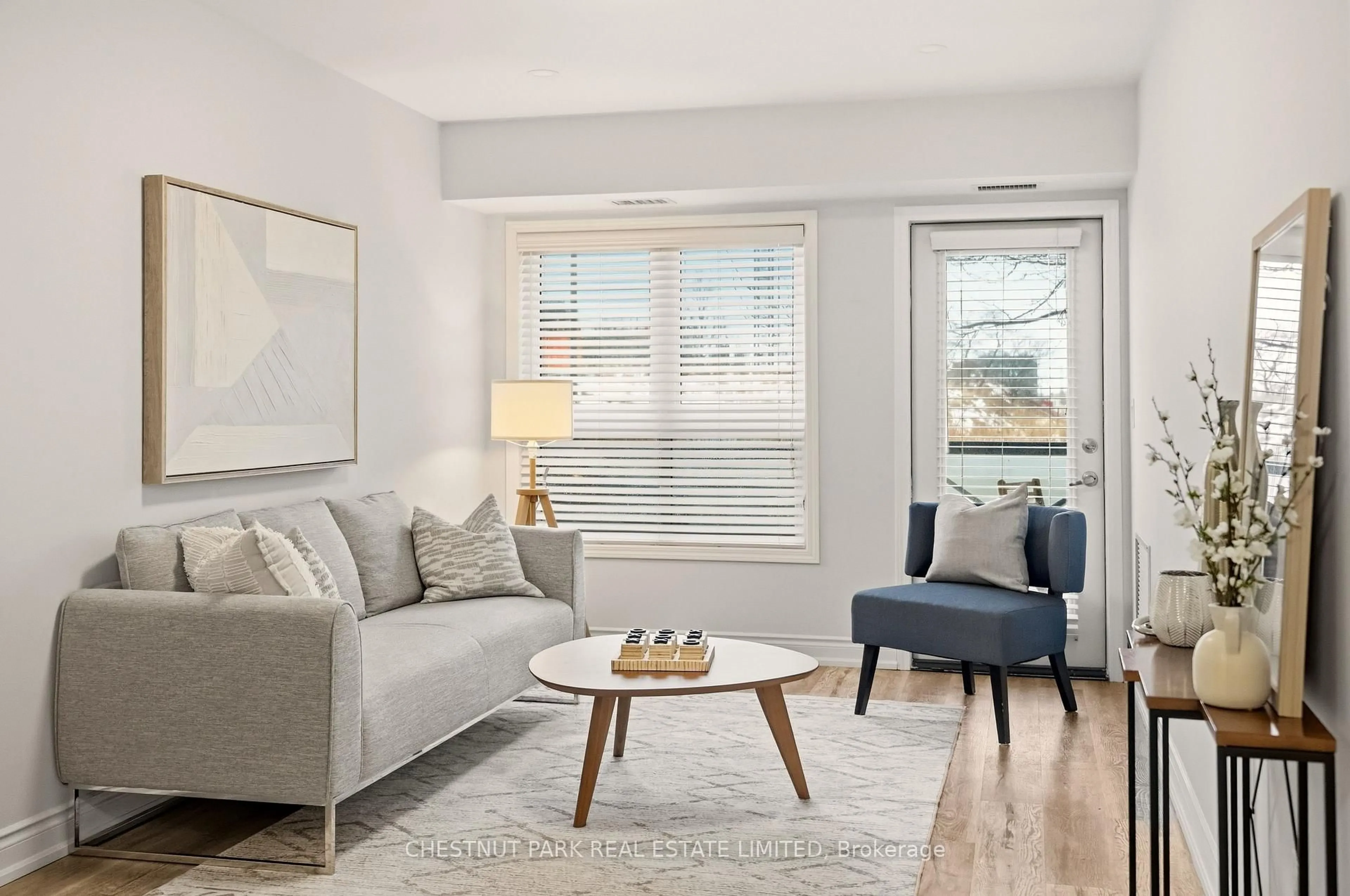 Living room with furniture, wood/laminate floor for 1045 Nadalin Hts #108, Milton Ontario L9T 8R5