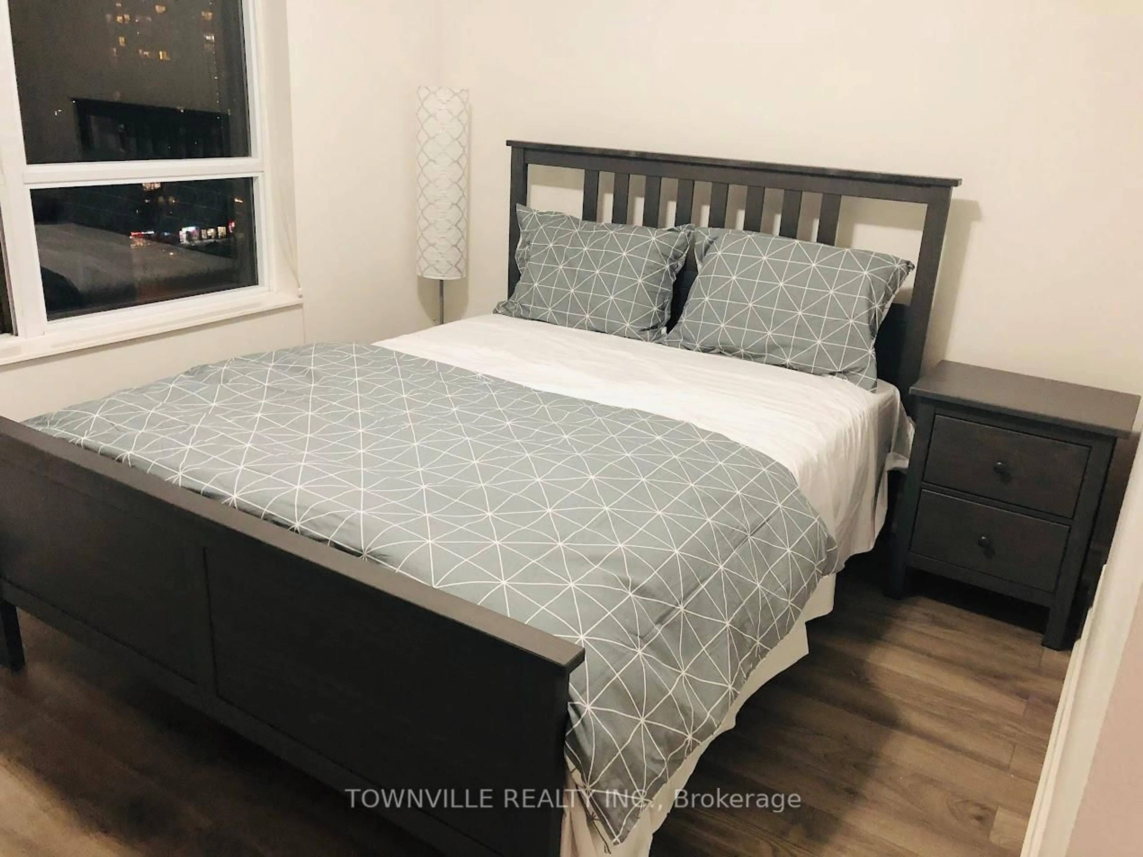 Bedroom with bed, wood/laminate floor for 310 Burnhamthorpe Rd #1912, Mississauga Ontario L5B 4P9