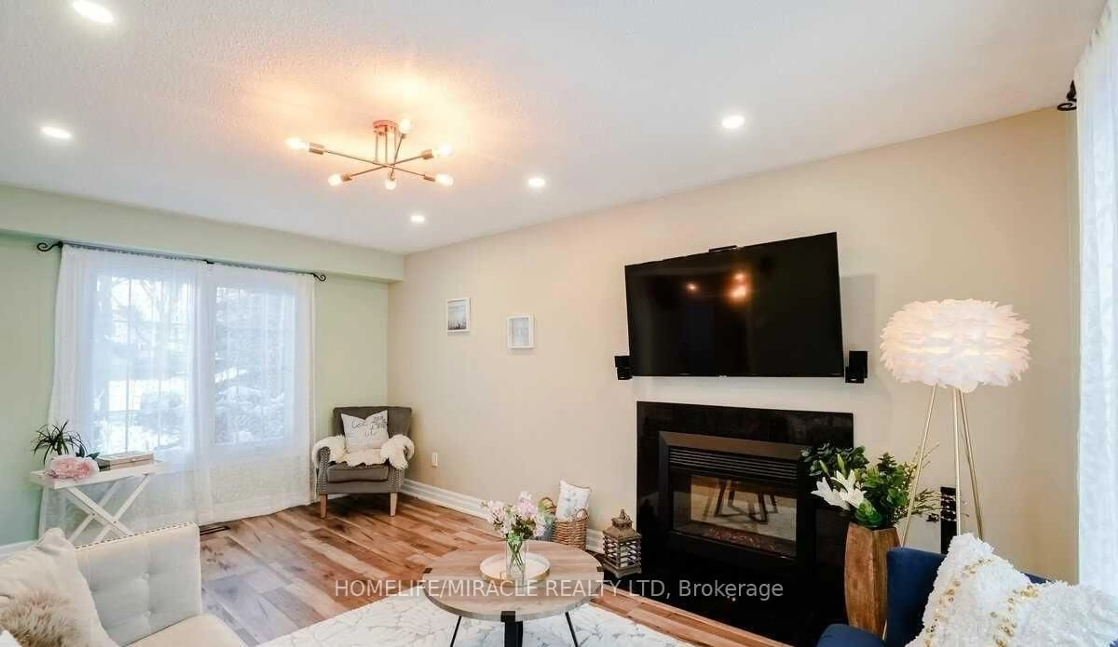 Living room with furniture, wood/laminate floor for 2 Cantrill Crt, Brampton Ontario L6Z 1A3