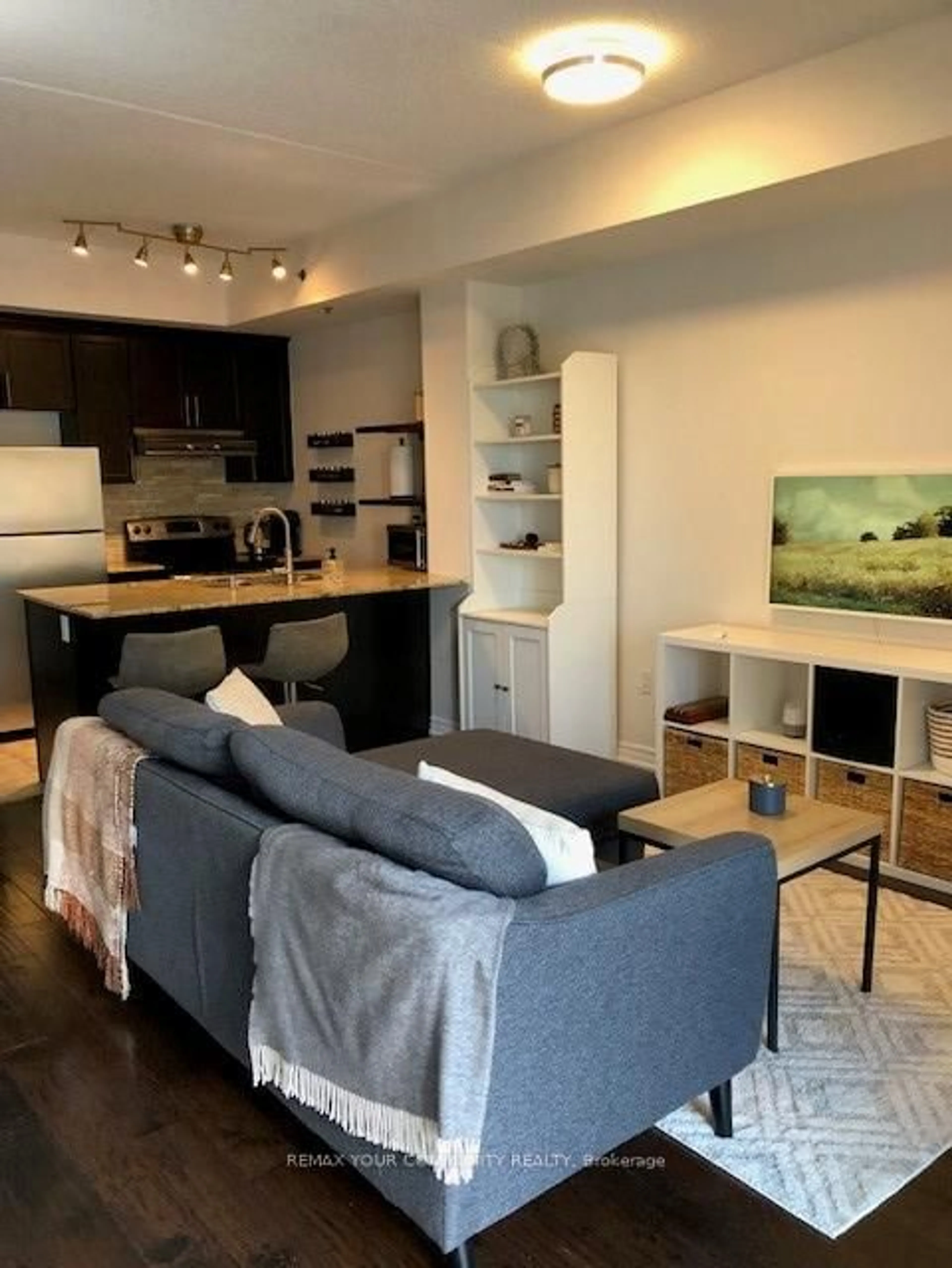 Living room with furniture, wood/laminate floor for 1421 Costigan Rd #414, Milton Ontario L9T 2N4