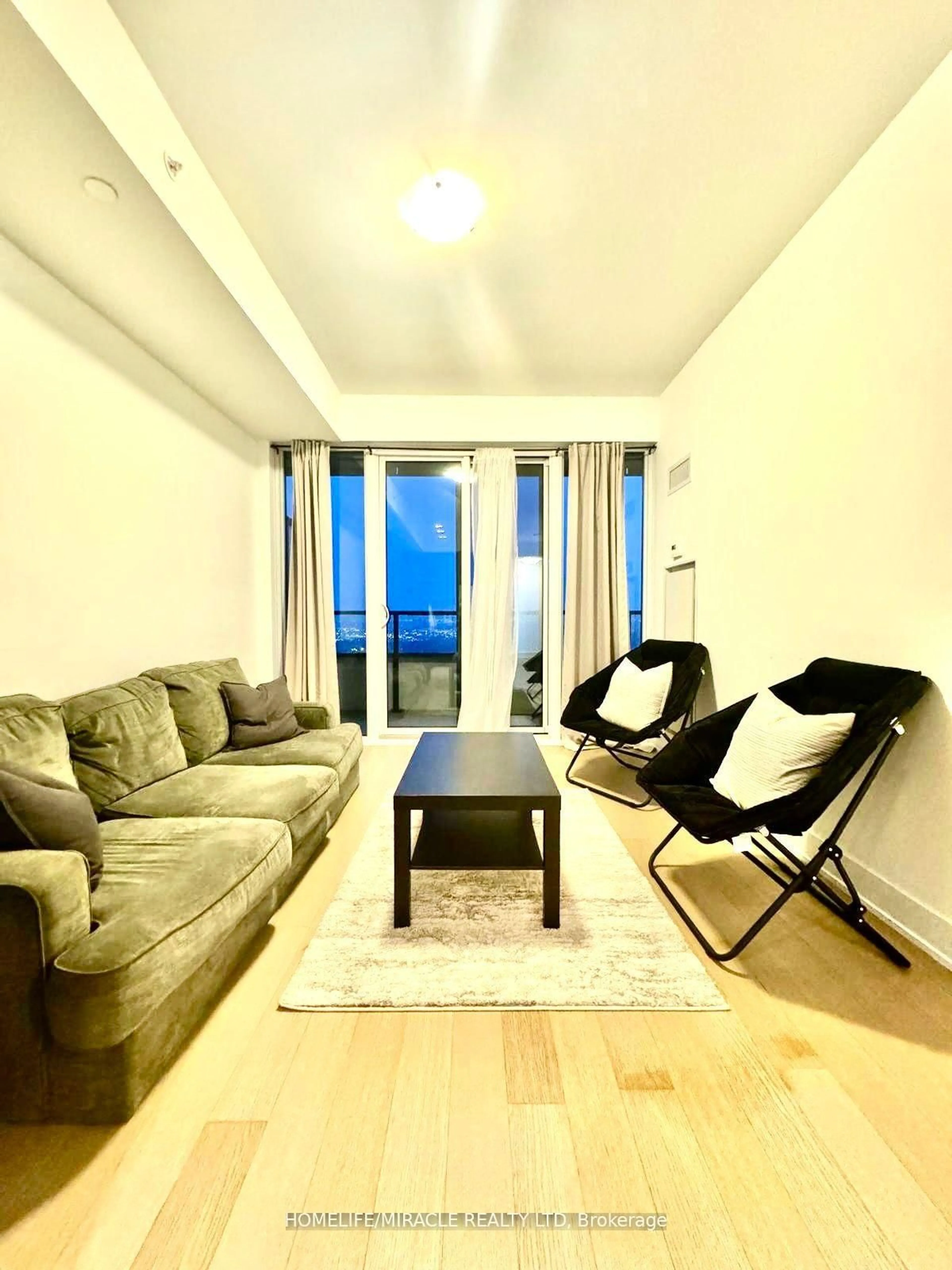 Living room with furniture, wood/laminate floor for 30 Shore Breeze Dr Dr #5901, Toronto Ontario M8V 1A1