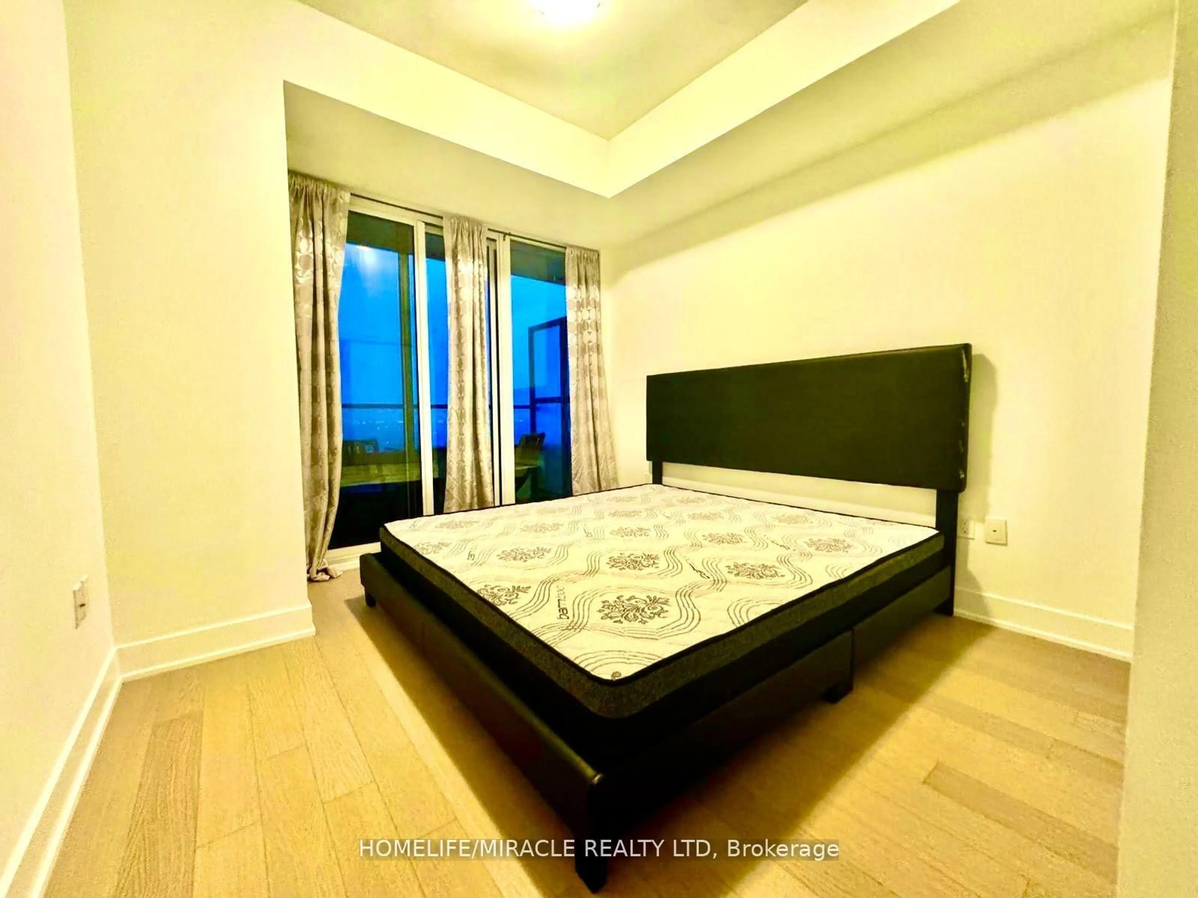 Bedroom with bed, wood/laminate floor for 30 Shore Breeze Dr Dr #5901, Toronto Ontario M8V 1A1
