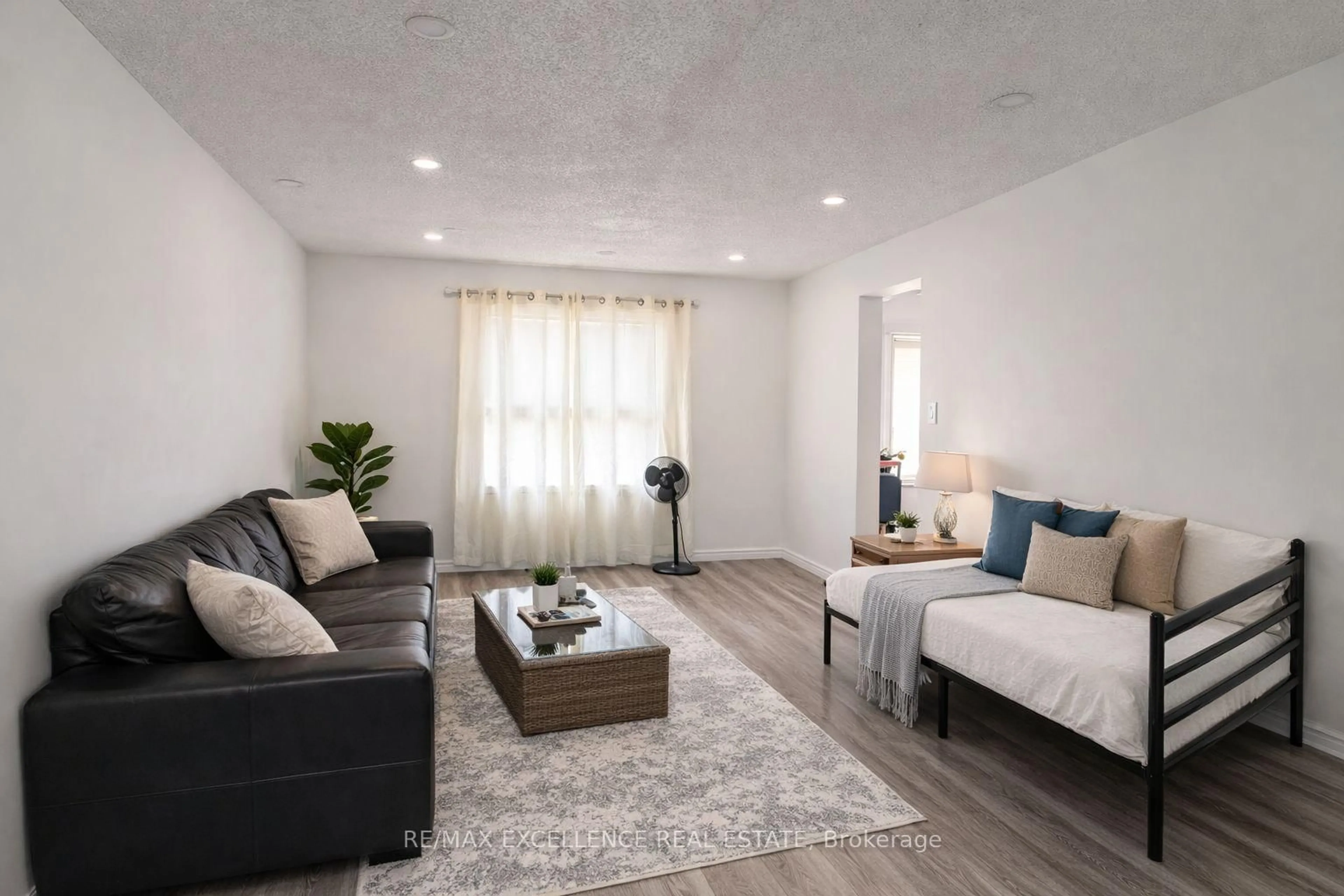 Living room with furniture, wood/laminate floor for 68 Alabaster Dr, Brampton Ontario L6V 4G4