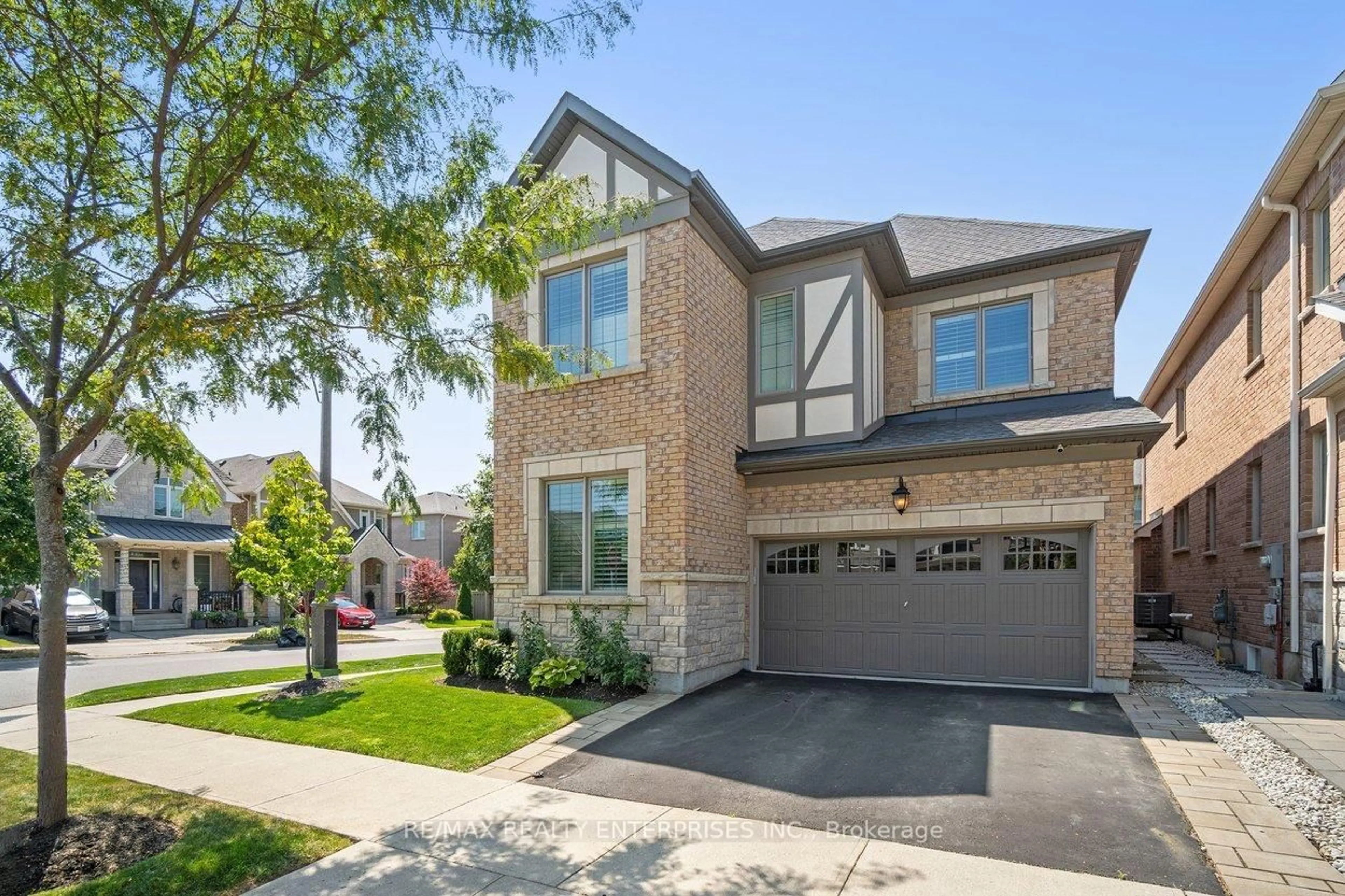 Home with brick exterior material, street for 355 Wisteria Way, Oakville Ontario L6M 1L6