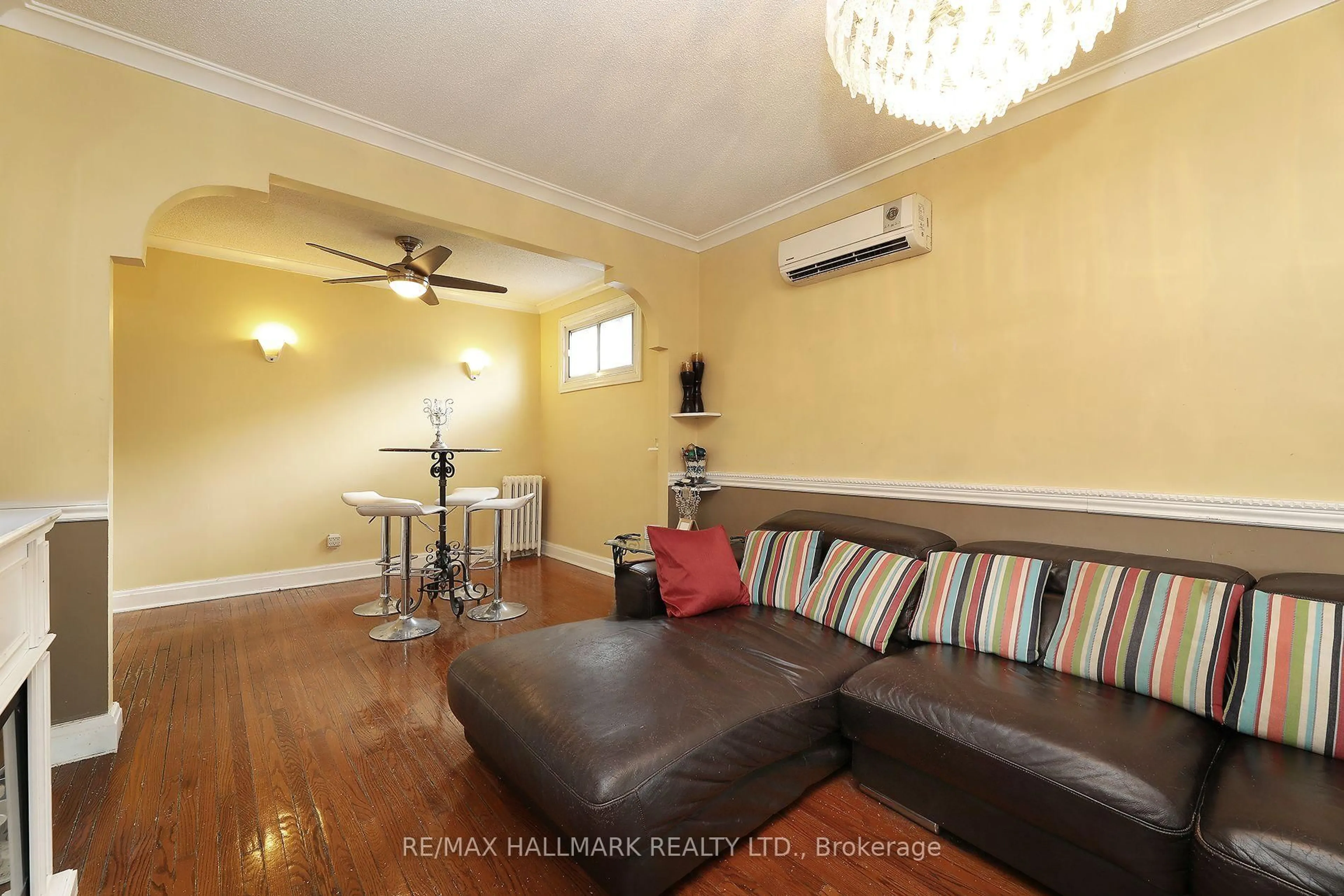 Living room with furniture, wood/laminate floor for 2095 Keele St, Toronto Ontario M6M 3Y8
