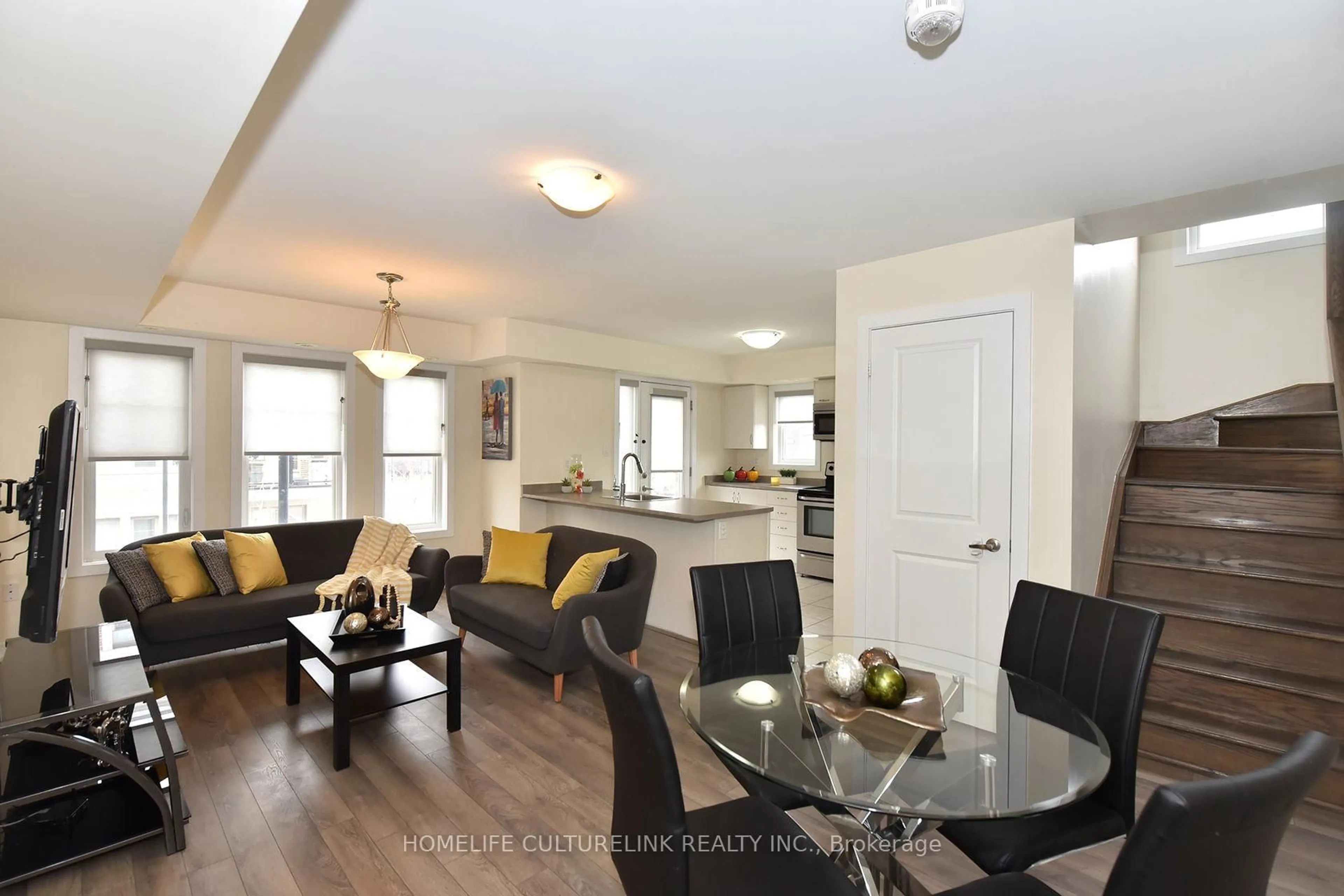 Living room with furniture, wood/laminate floor for 100 Parrotta Dr #89, Toronto Ontario M9M 0B5