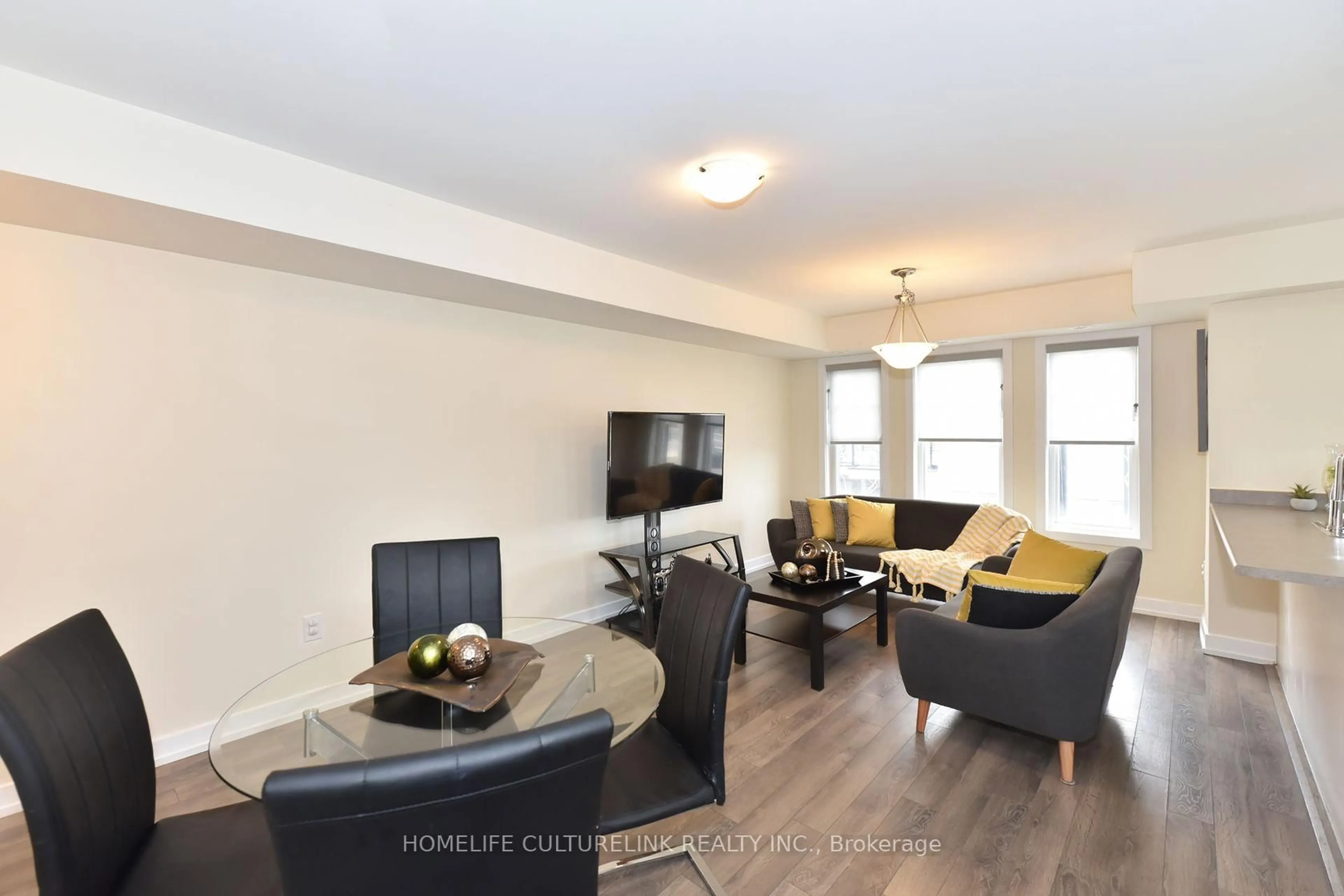 Living room with furniture, wood/laminate floor for 100 Parrotta Dr #89, Toronto Ontario M9M 0B5