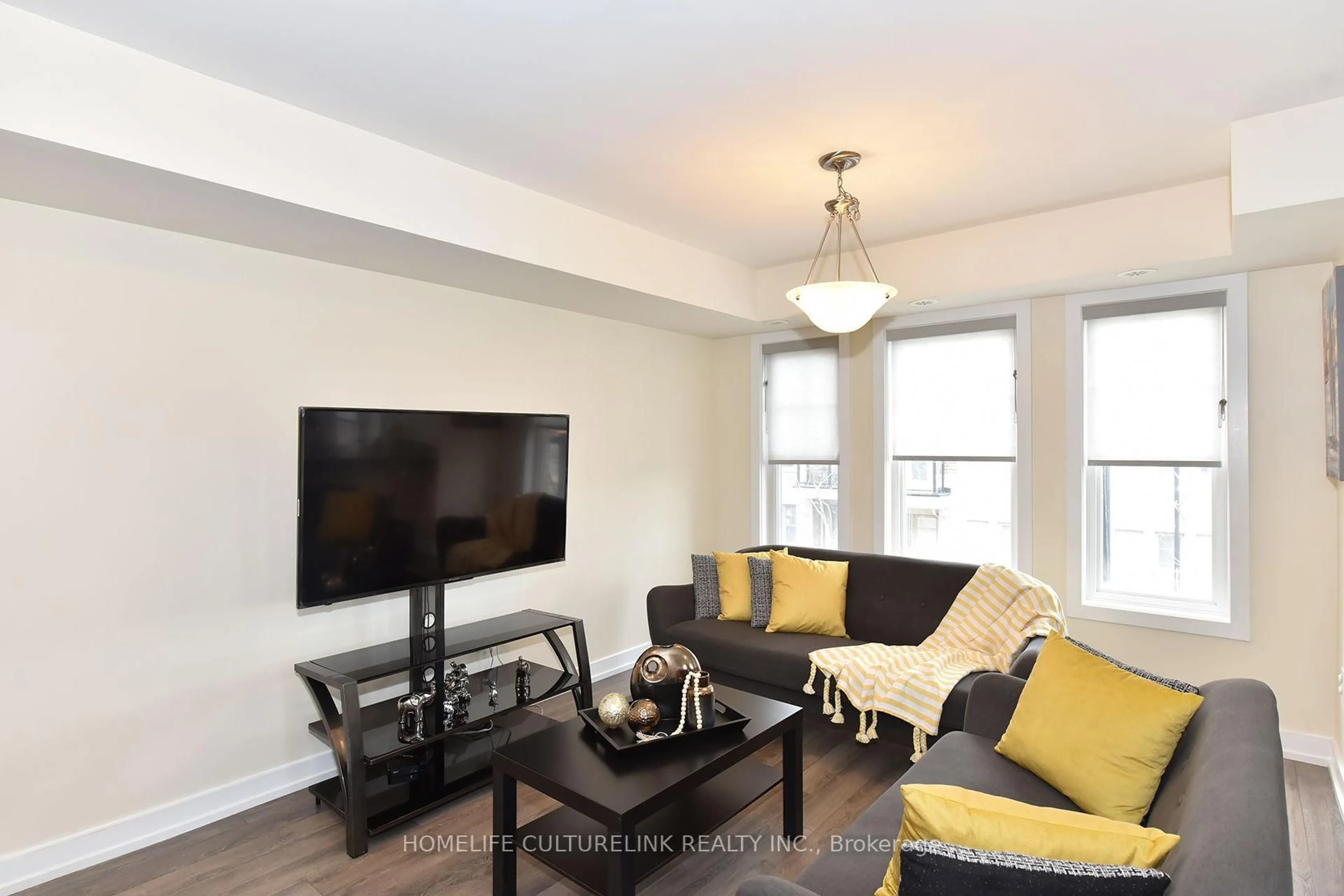 Living room with furniture, wood/laminate floor for 100 Parrotta Dr #89, Toronto Ontario M9M 0B5