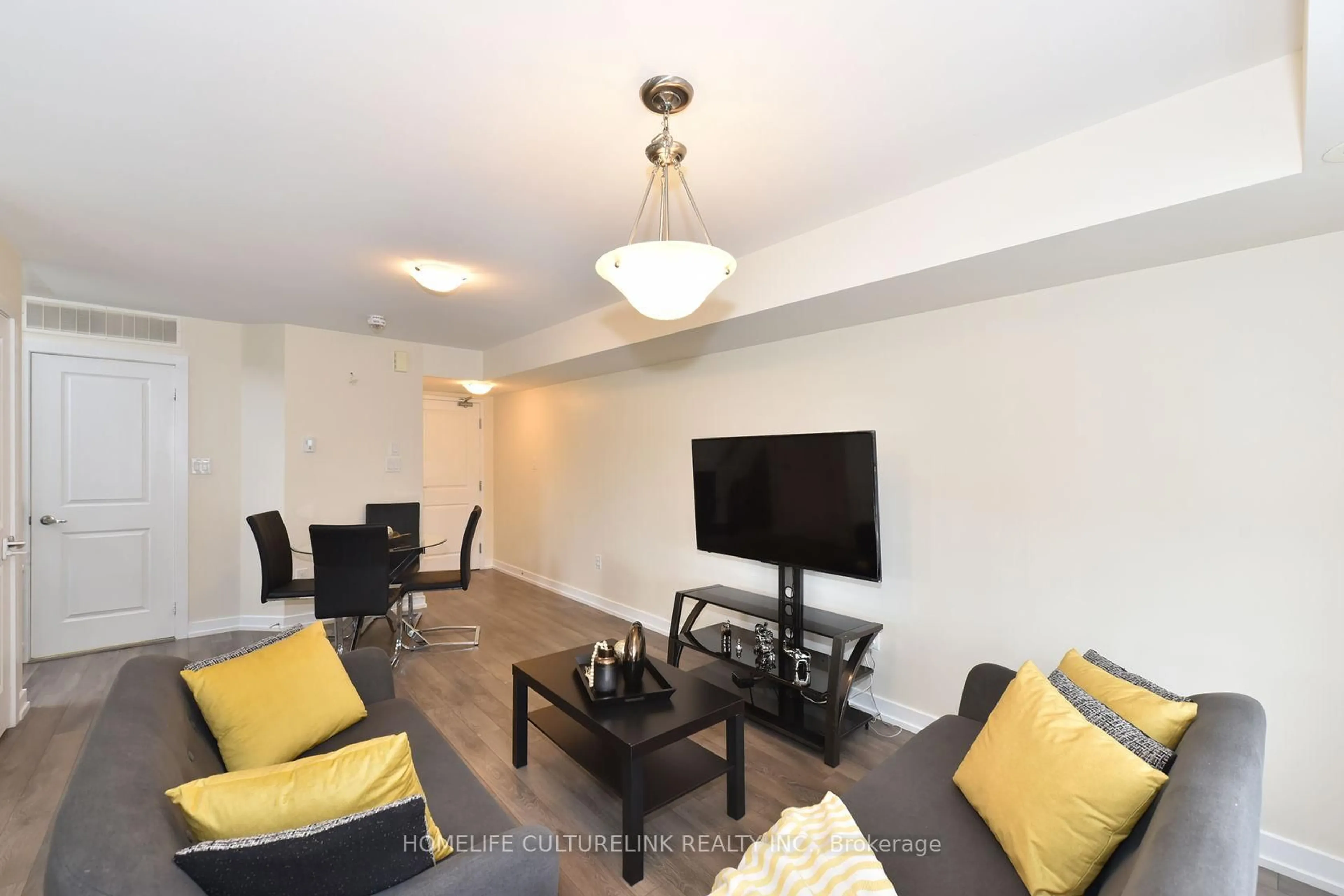 Living room with furniture, wood/laminate floor for 100 Parrotta Dr #89, Toronto Ontario M9M 0B5