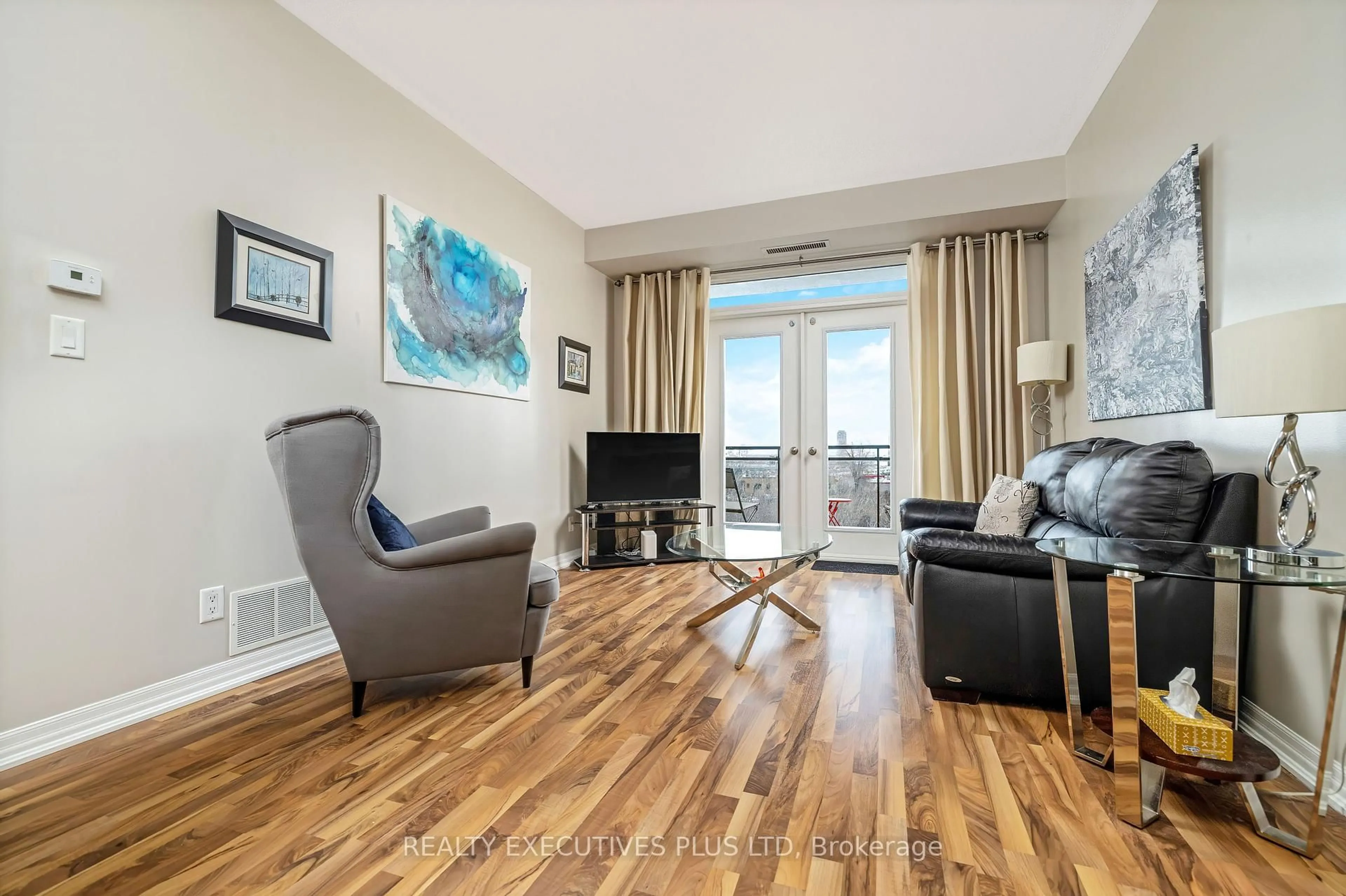 Living room with furniture, wood/laminate floor for 245 Dalesford Rd #414, Toronto Ontario M8Y 4H7