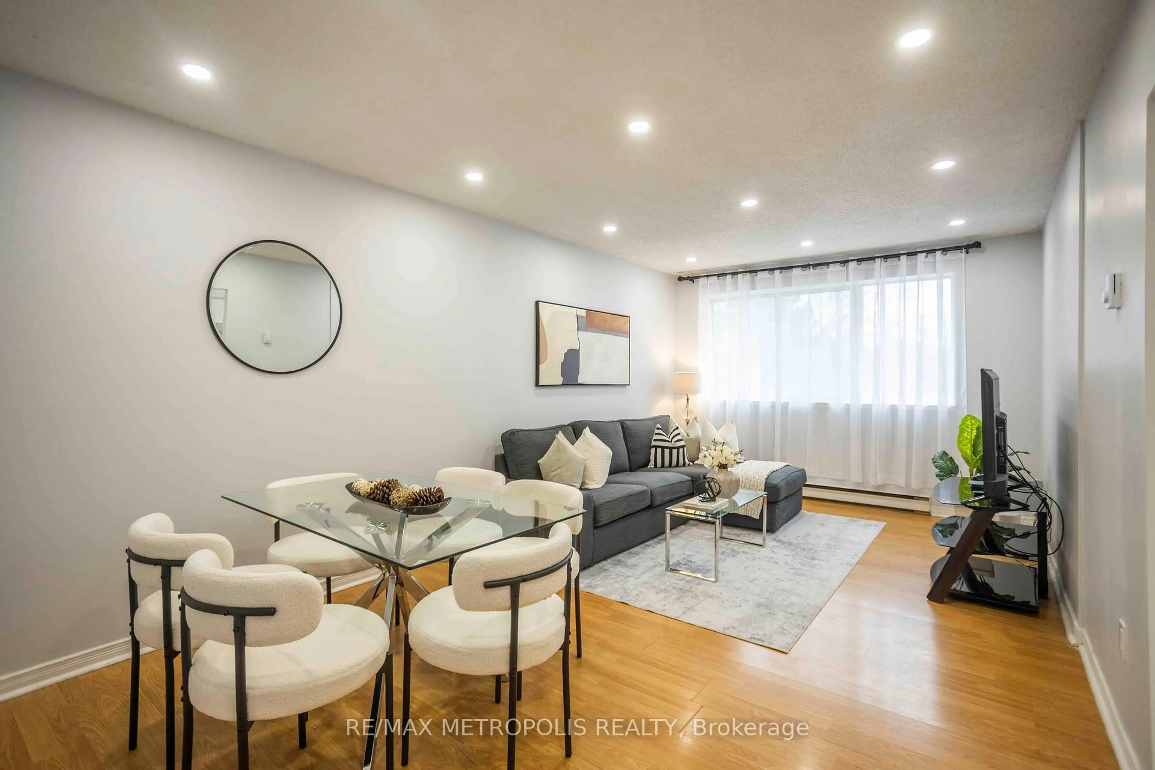 Living room with furniture, wood/laminate floor for 2170 Bromsgrove Rd #189, Mississauga Ontario L5J 4J2