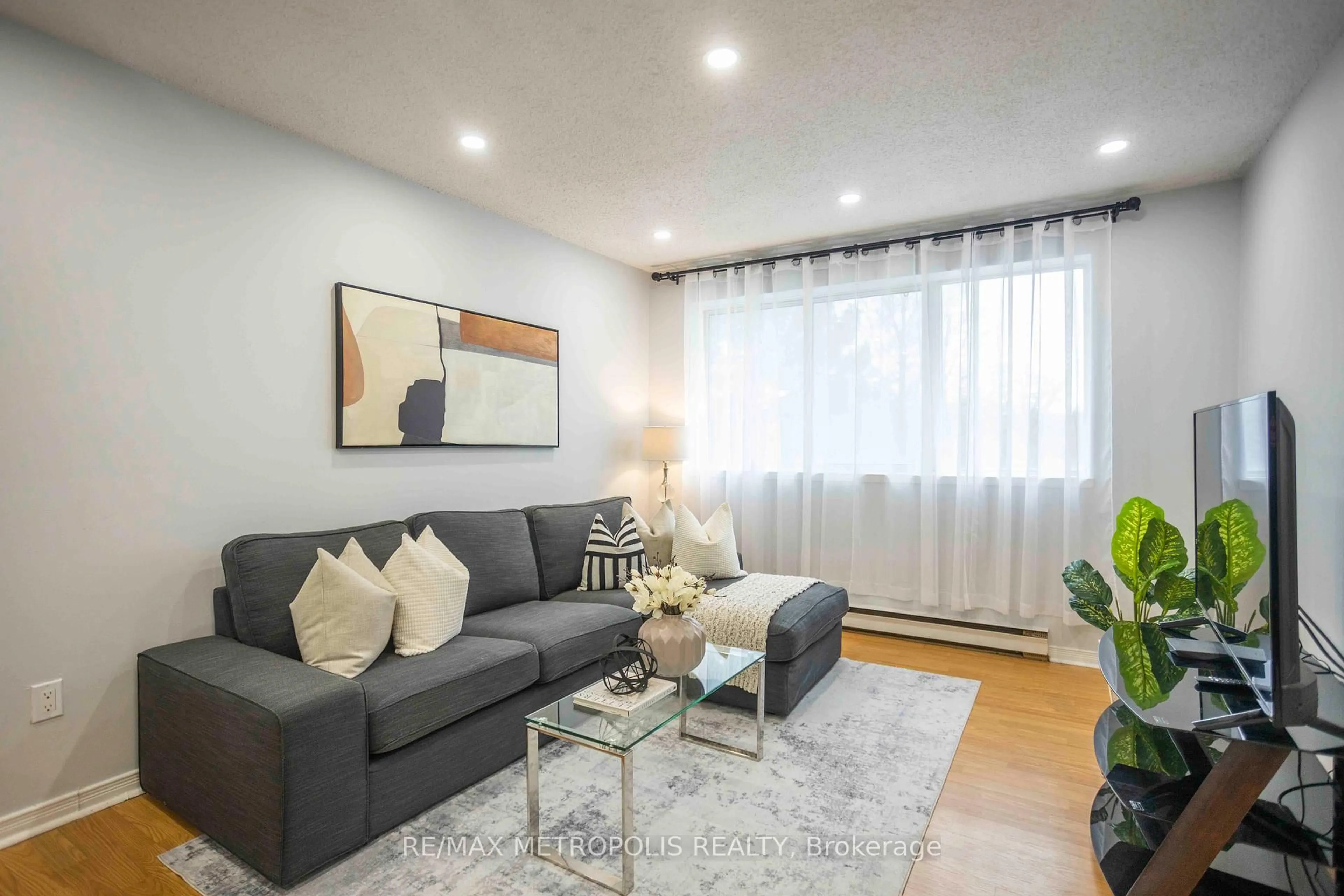 Living room with furniture, wood/laminate floor for 2170 Bromsgrove Rd #189, Mississauga Ontario L5J 4J2