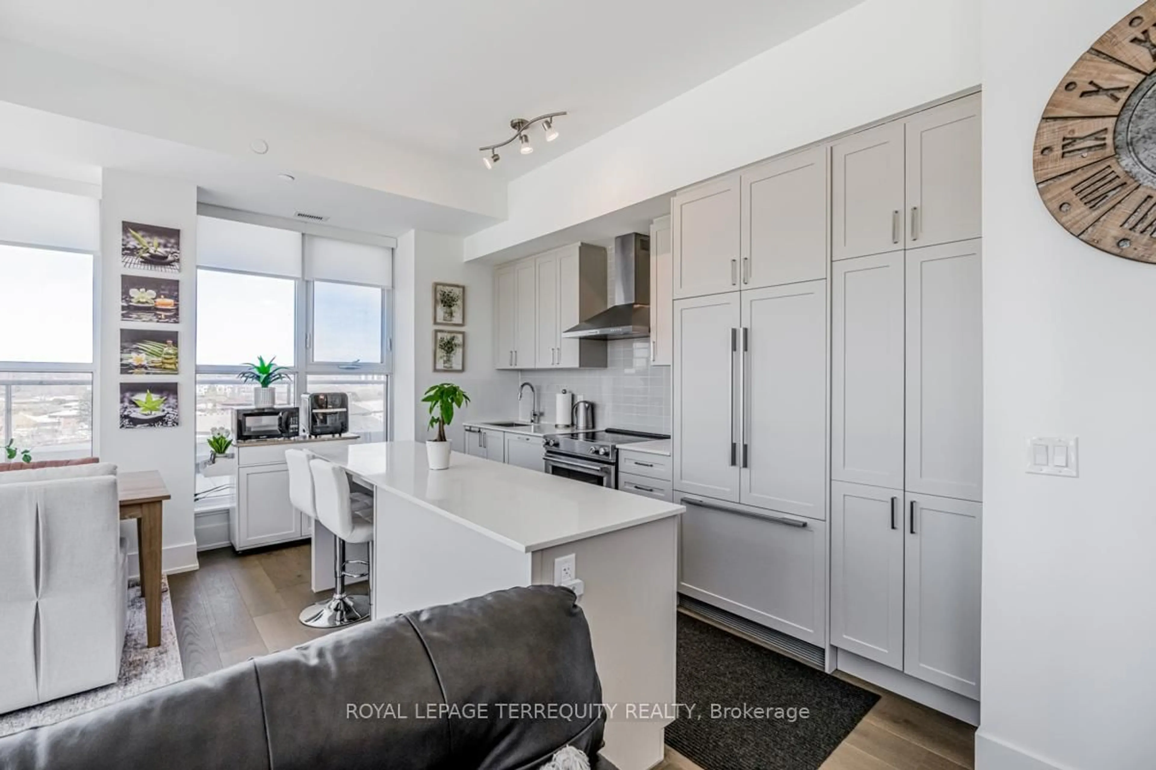 Open concept kitchen, wood/laminate floor for 1063 Douglas McCurdy Common #702, Mississauga Ontario L5G 0C5