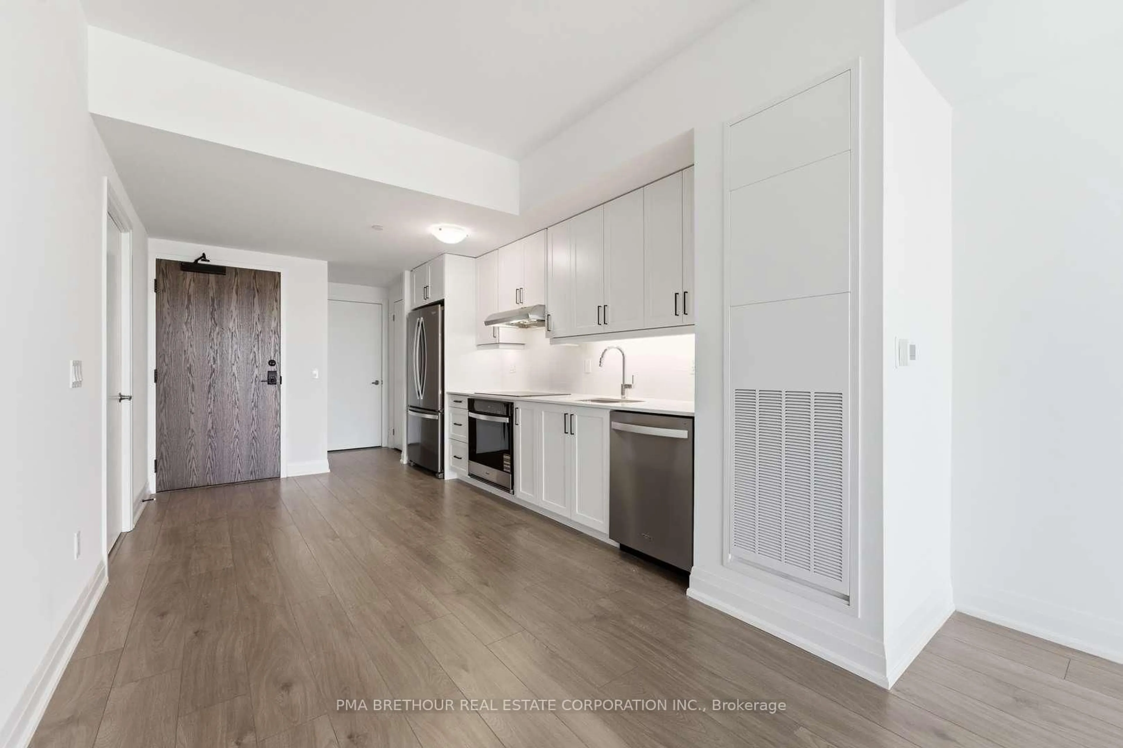Open concept kitchen, wood/laminate floor for 1035 Southdown Rd #1811, Mississauga Ontario L5J 0A2
