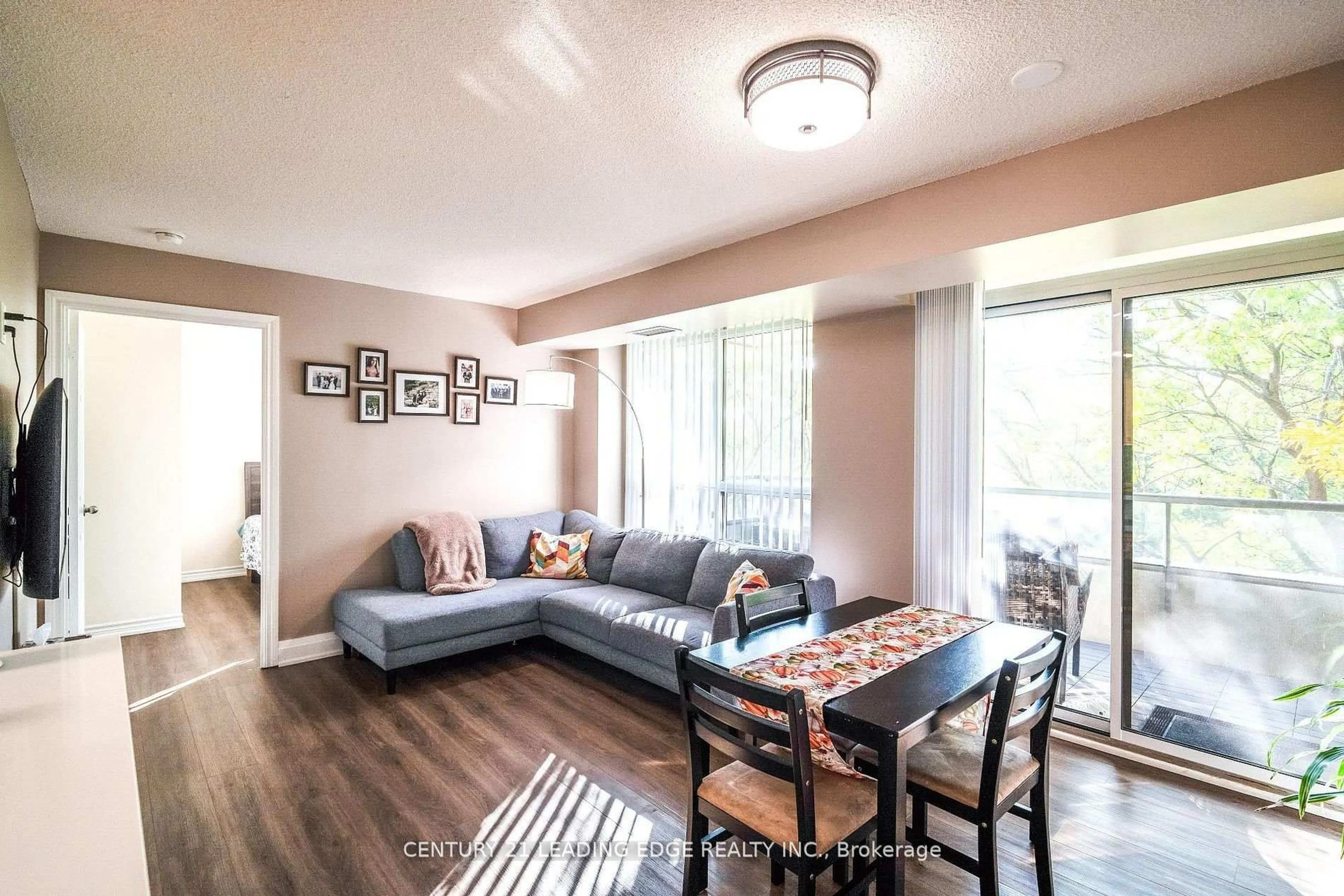 Living room with furniture, wood/laminate floor for 700 Humberwood Blvd #219, Toronto Ontario M9W 7J4