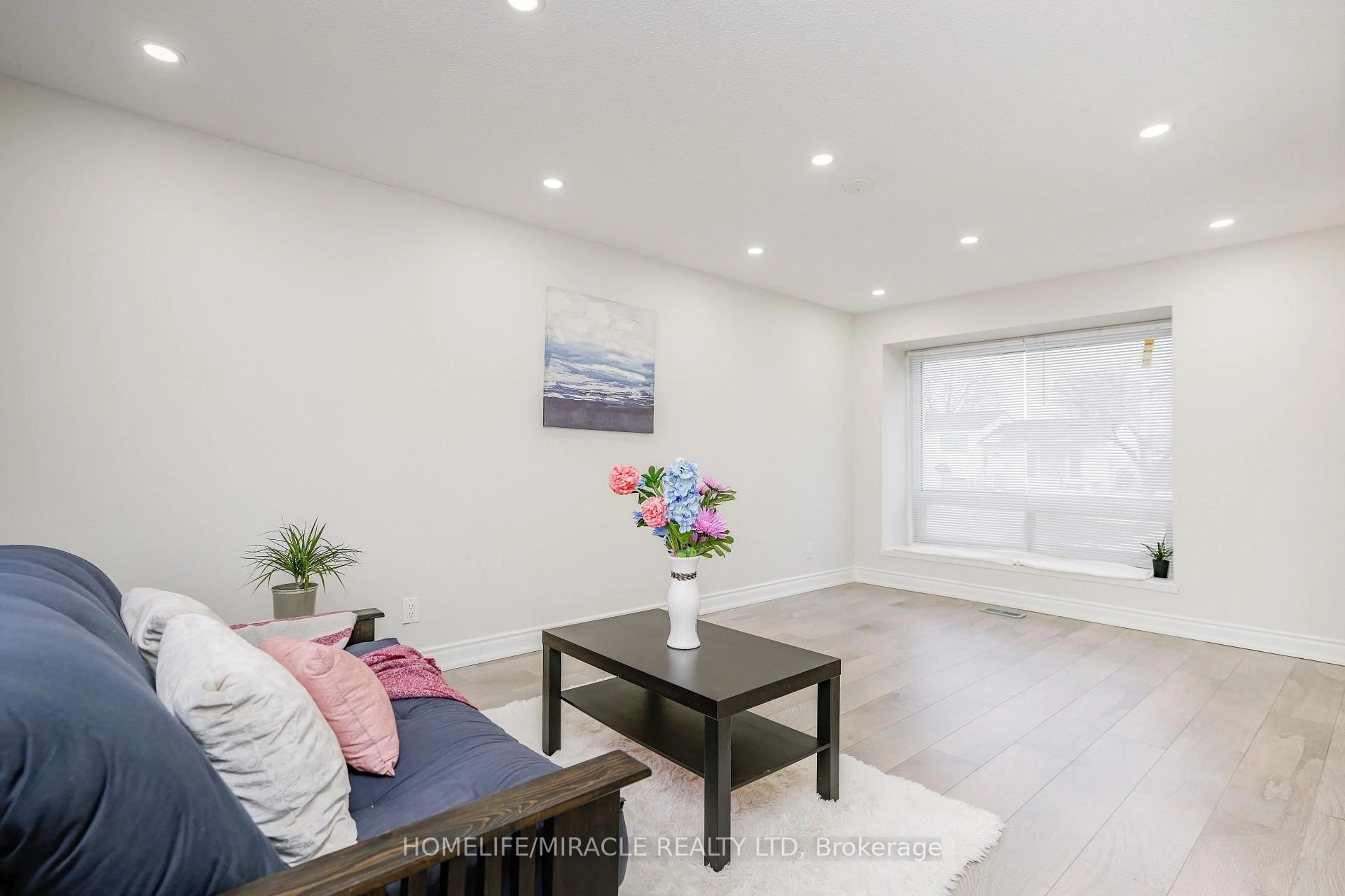 Living room with furniture, wood/laminate floor for 15 Heatherside Crt, Brampton Ontario L6S 1N9