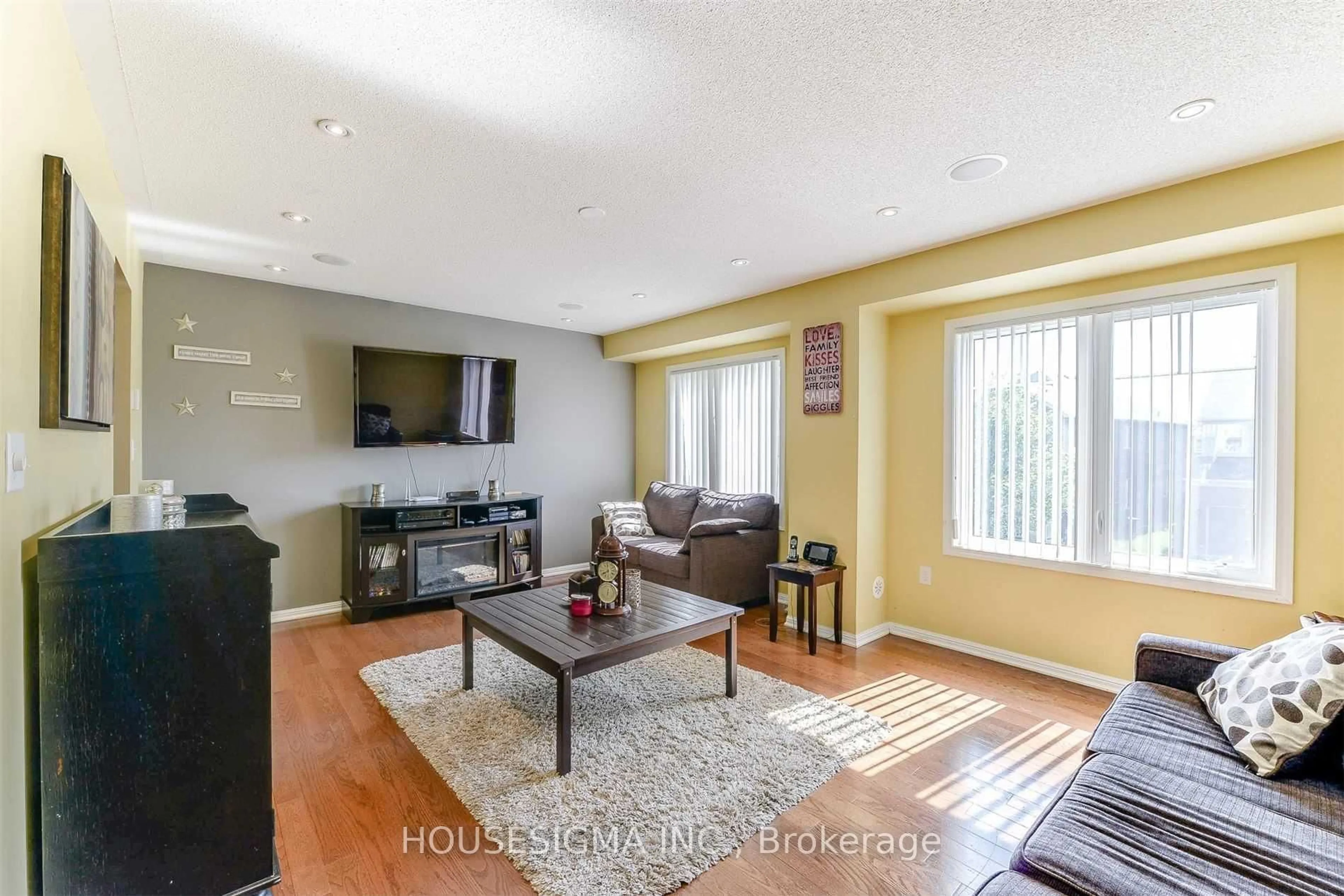Living room with furniture, wood/laminate floor for 92 Lathbury St, Brampton Ontario L7A 0R8