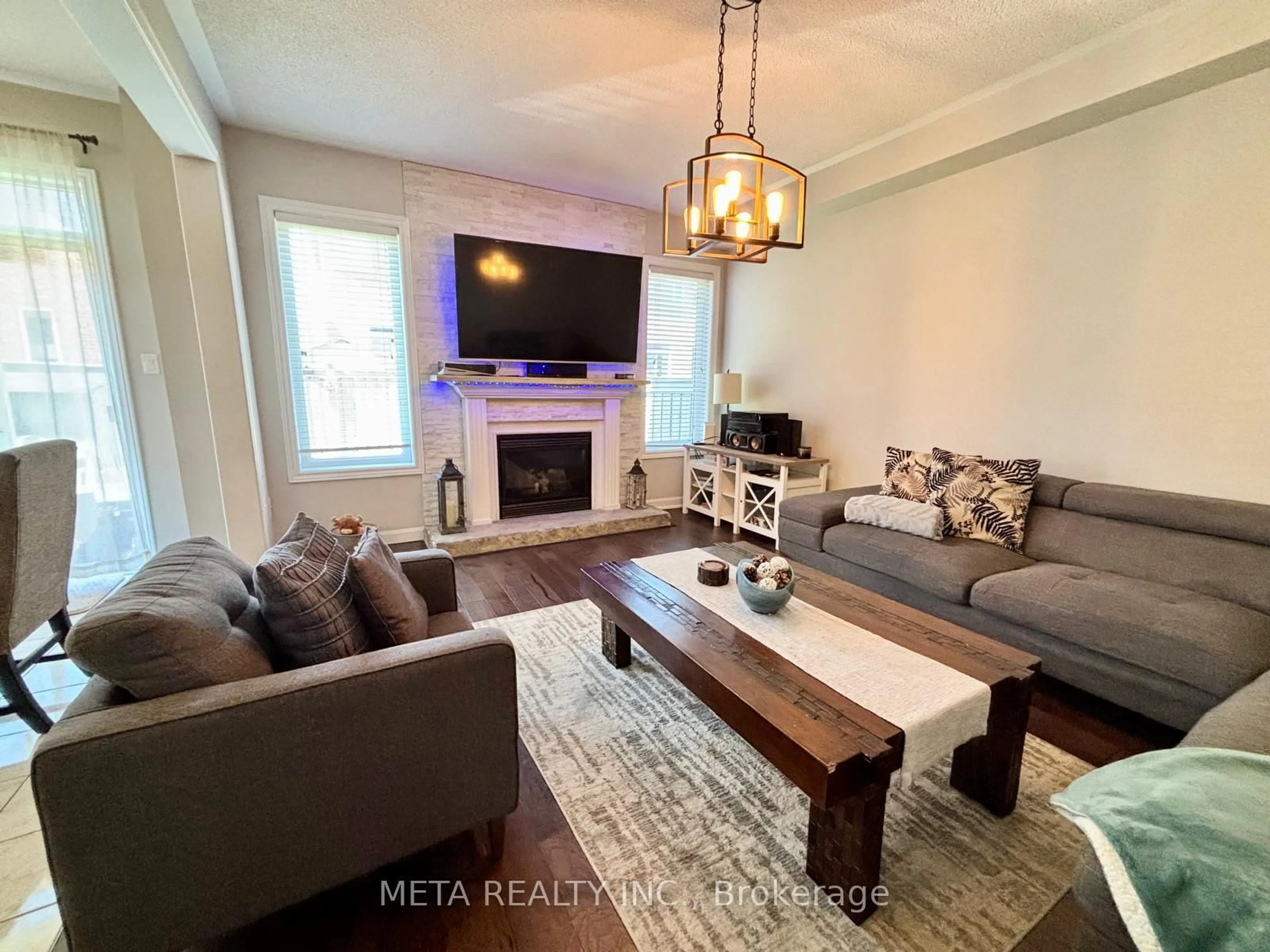 Living room with furniture, wood/laminate floor for 102 Begonia Cres, Brampton Ontario L7A 0M7