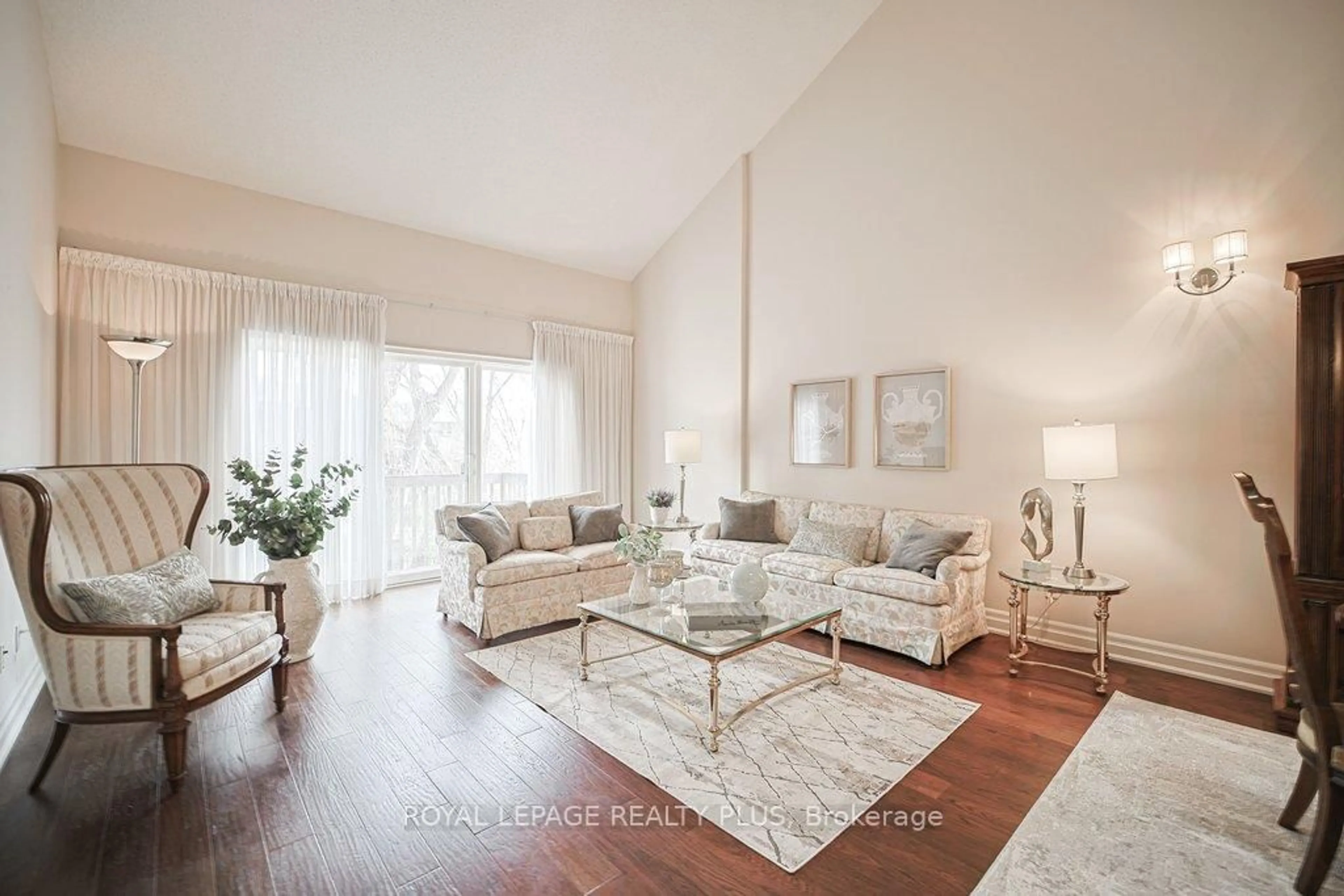 Living room with furniture, wood/laminate floor for 1010 Cristina Crt #7, Mississauga Ontario L5J 4T7
