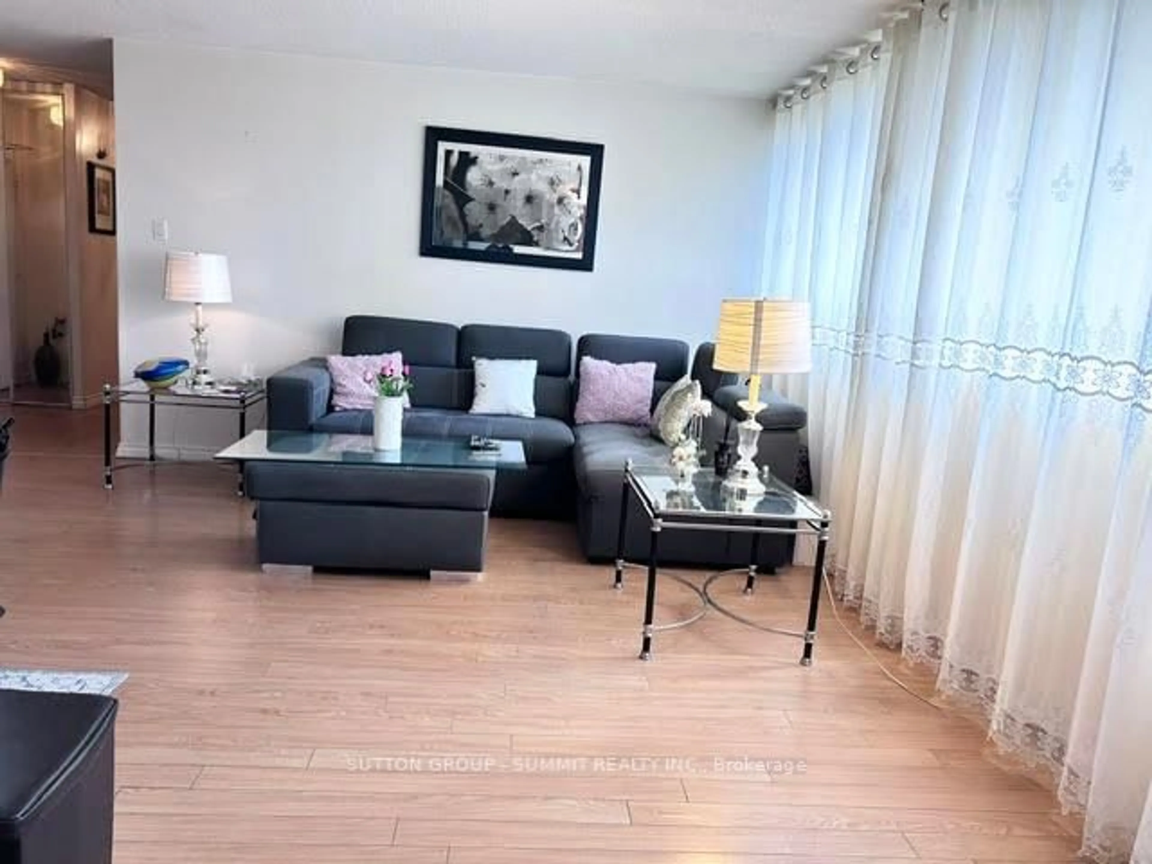 Living room with furniture, wood/laminate floor for 3590 Kaneff Cres #408, Mississauga Ontario L5A 3X3