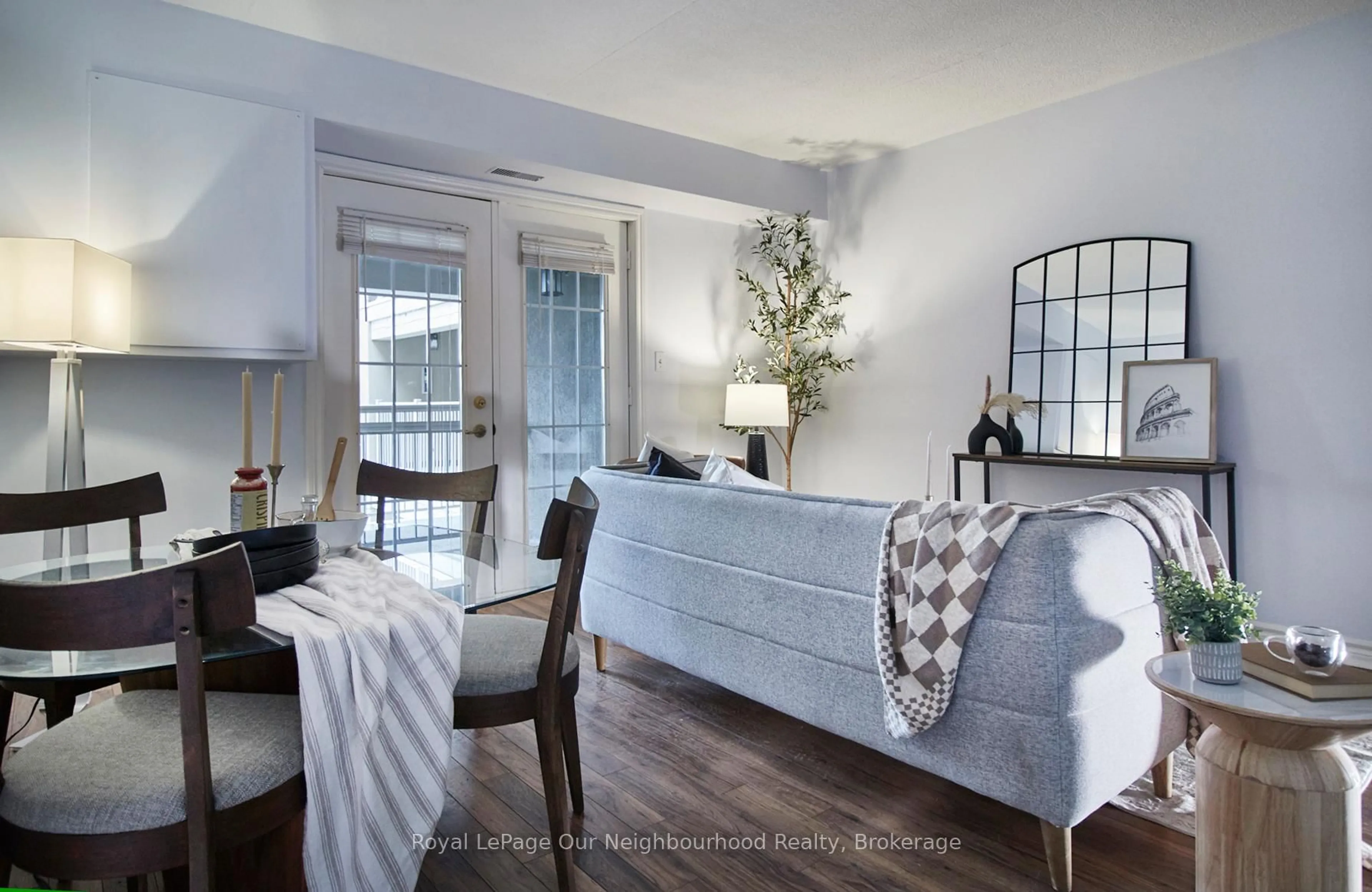 Living room with furniture, wood/laminate floor for 1431 Walker's Line #208, Burlington Ontario L7M 4N9