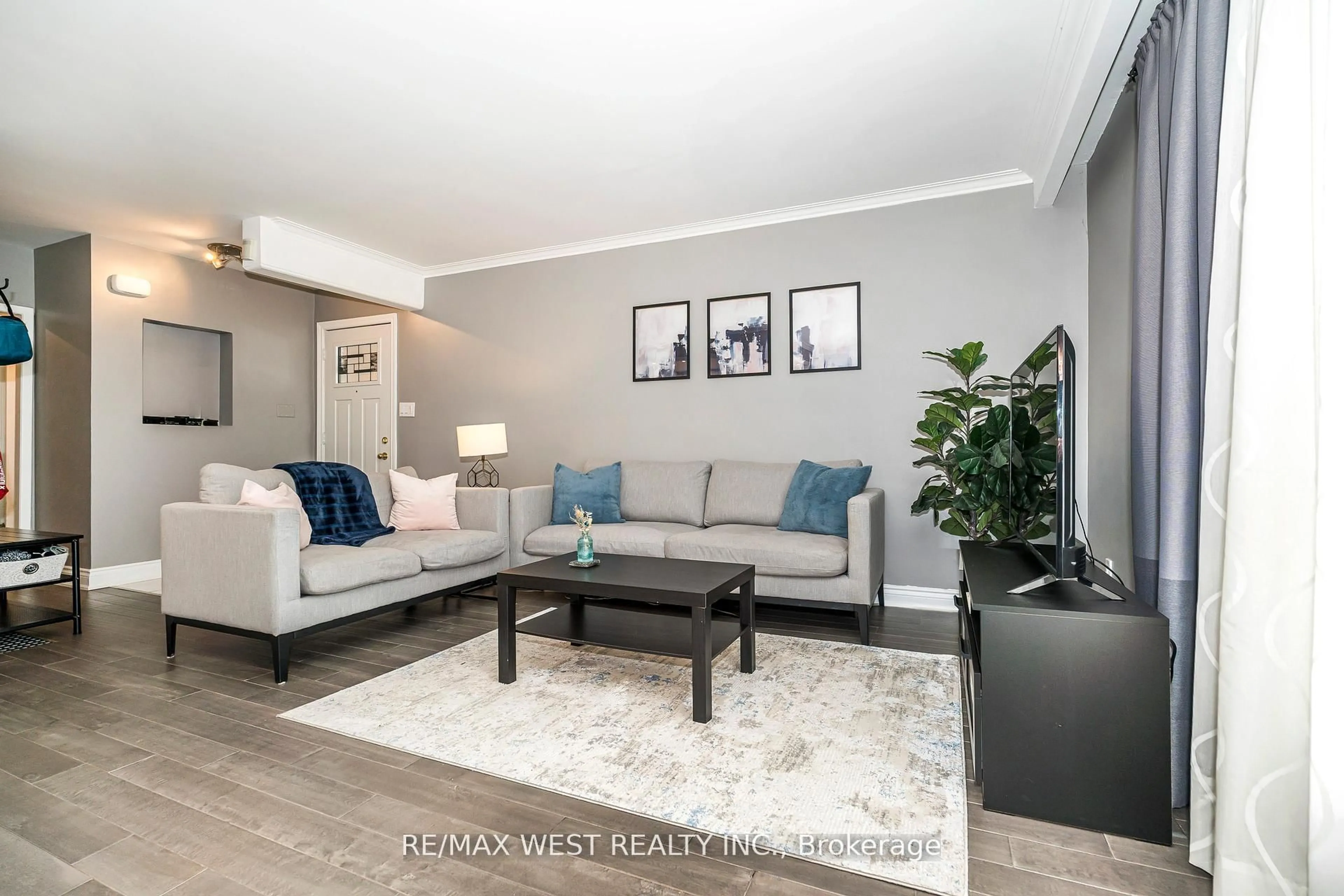 Living room with furniture, wood/laminate floor for 22 Dimplefield Pl, Toronto Ontario M9C 4A1