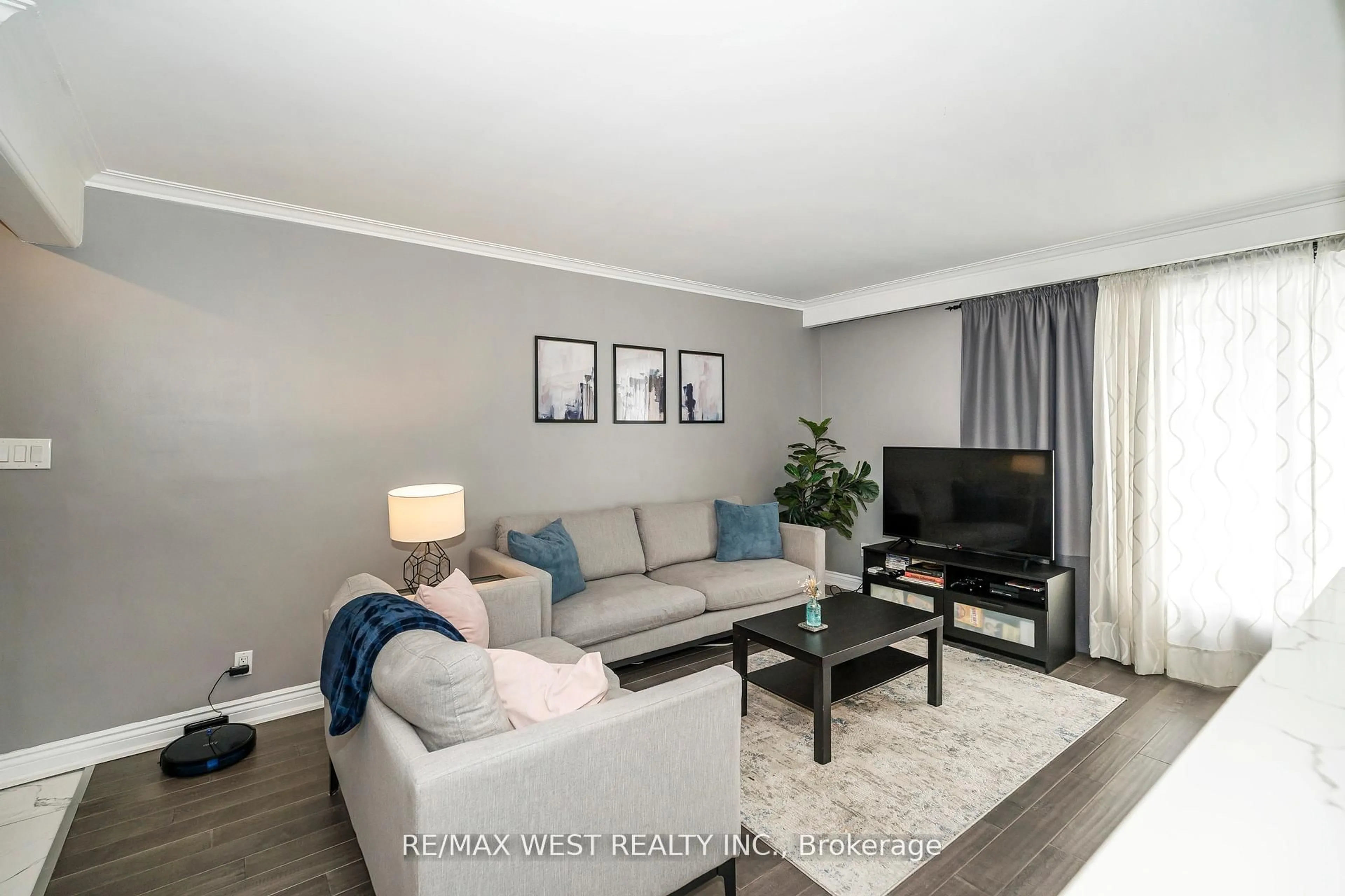 Living room with furniture, wood/laminate floor for 22 Dimplefield Pl, Toronto Ontario M9C 4A1