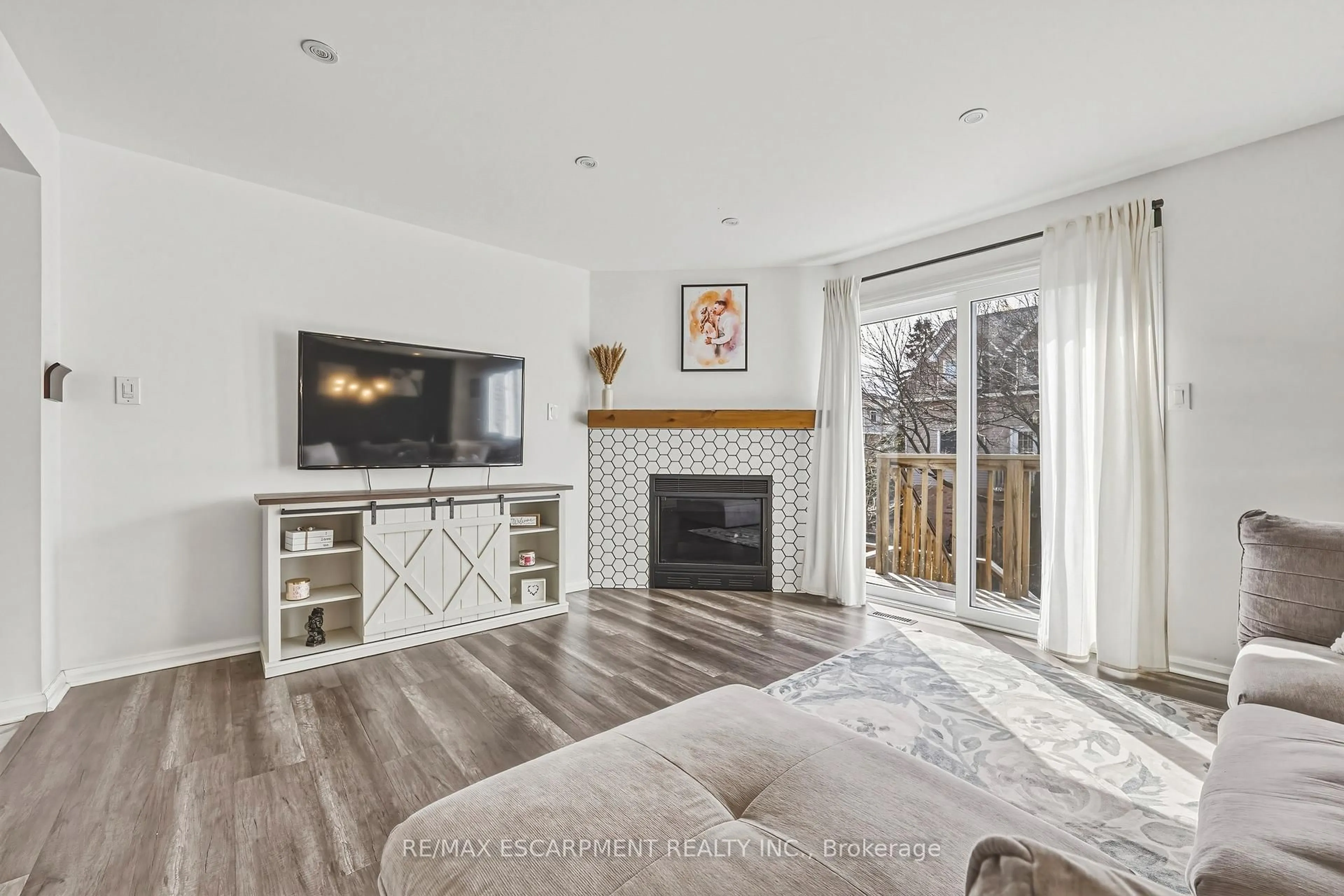 Living room with furniture, wood/laminate floor for 2055 Walkers Line #242, Burlington Ontario L7M 4B5