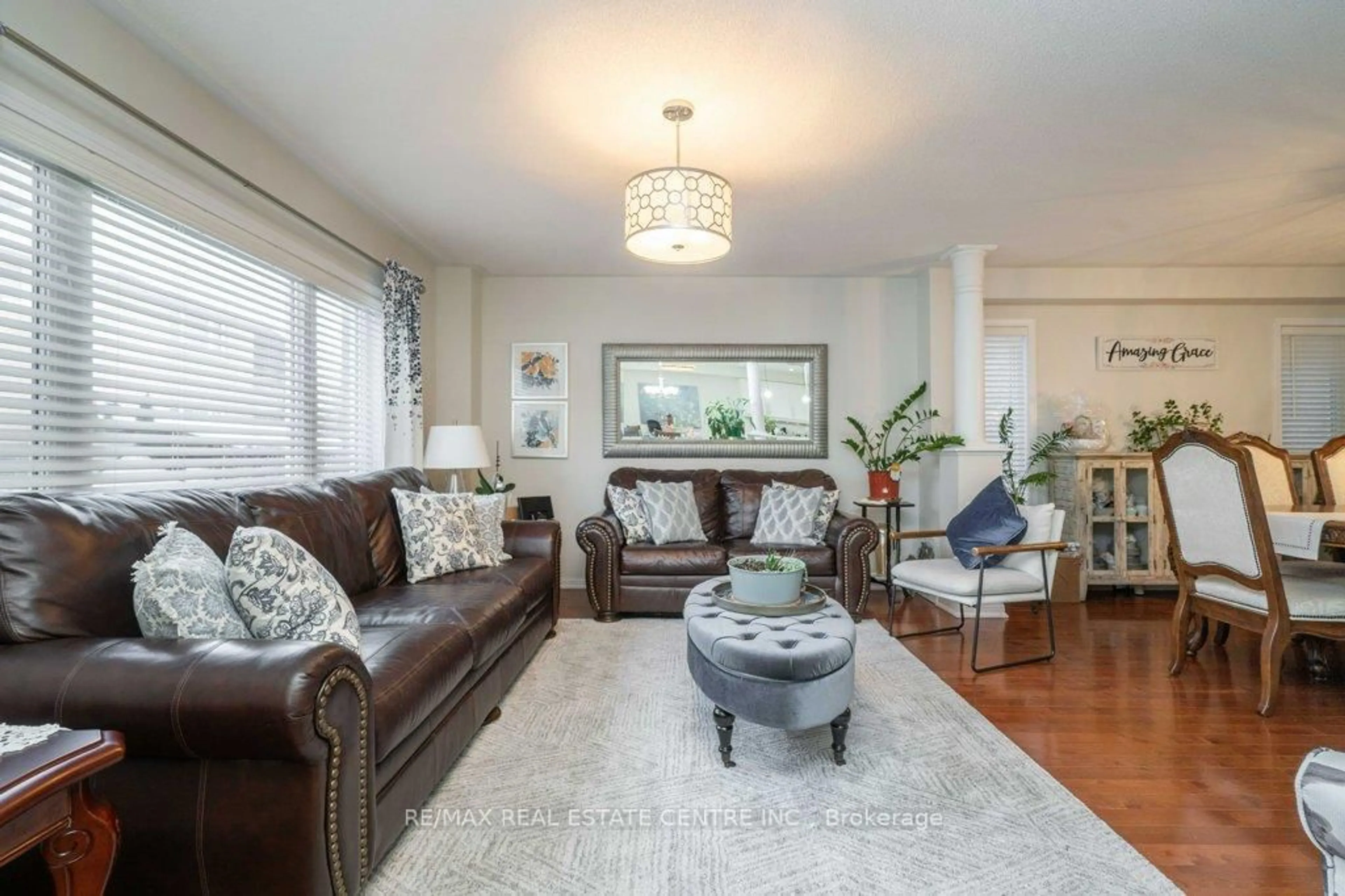 Living room with furniture, wood/laminate floor for 673 Armstrong Blvd, Milton Ontario L9T 0H4