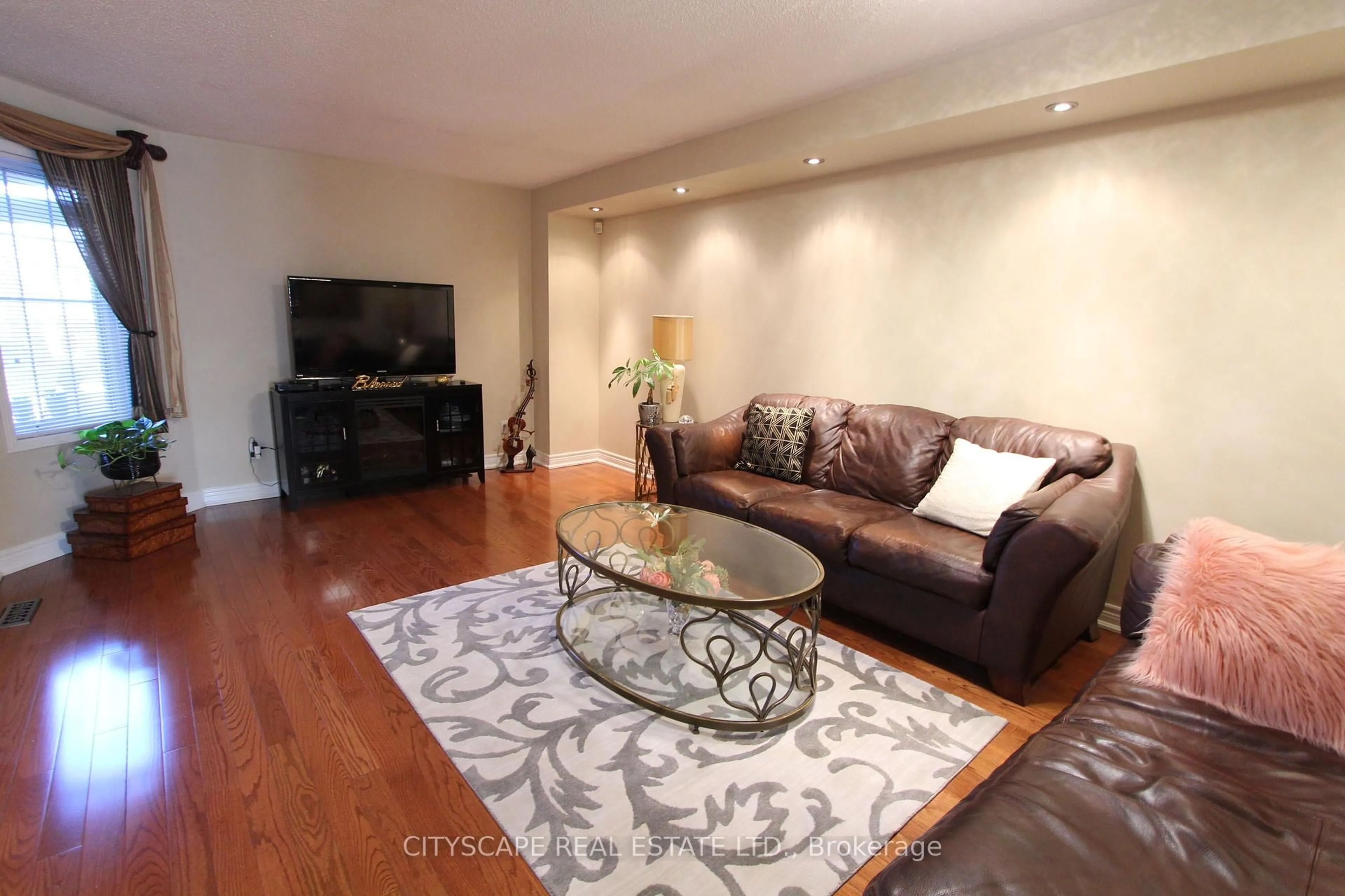 Living room with furniture, wood/laminate floor for 3162 Pearwood Pl, Mississauga Ontario L5B 4H1