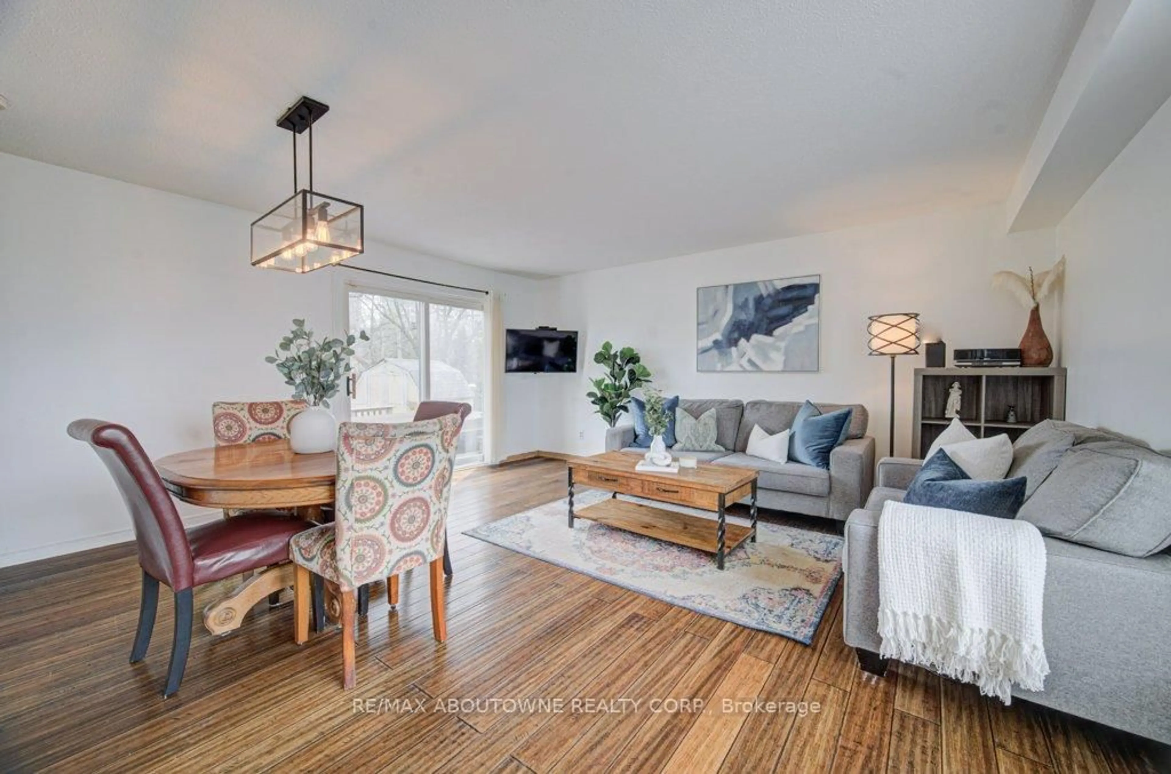 Living room with furniture, wood/laminate floor for 85 Huntingwood Cres, Brampton Ontario L6S 1S5