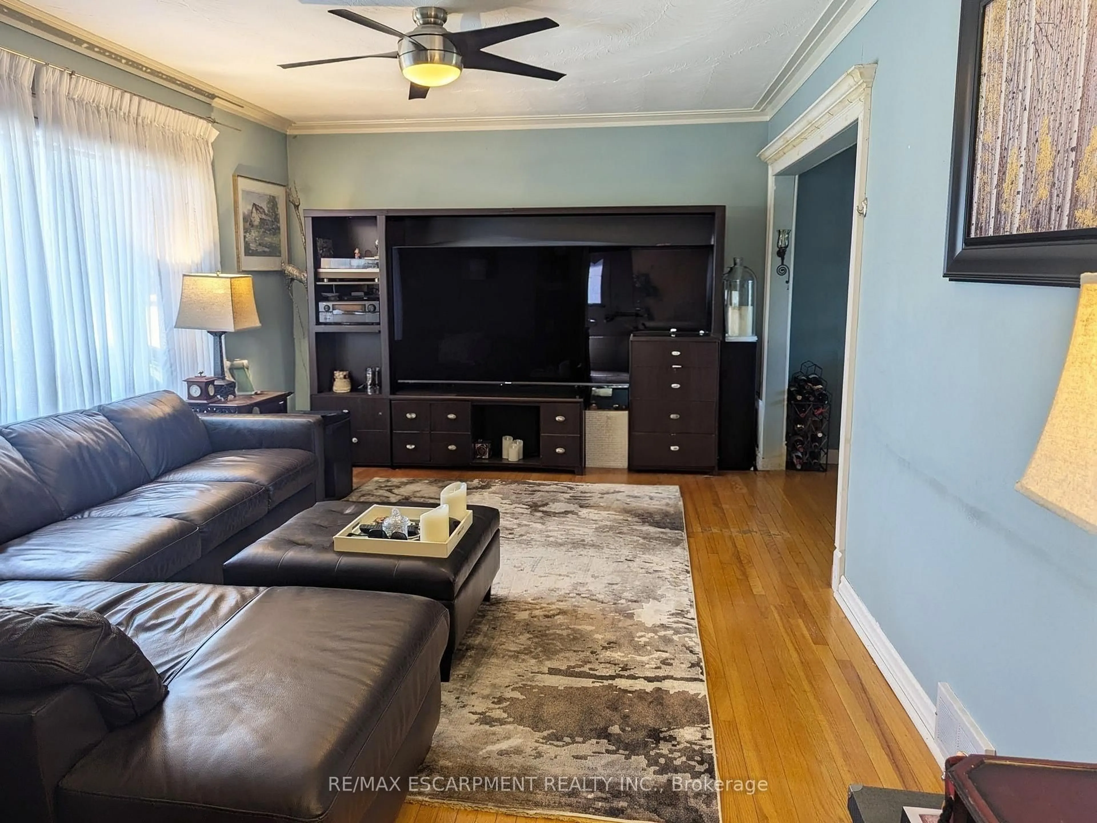 Living room with furniture, wood/laminate floor for 35 Marcia Ave, Toronto Ontario M6B 2Y6