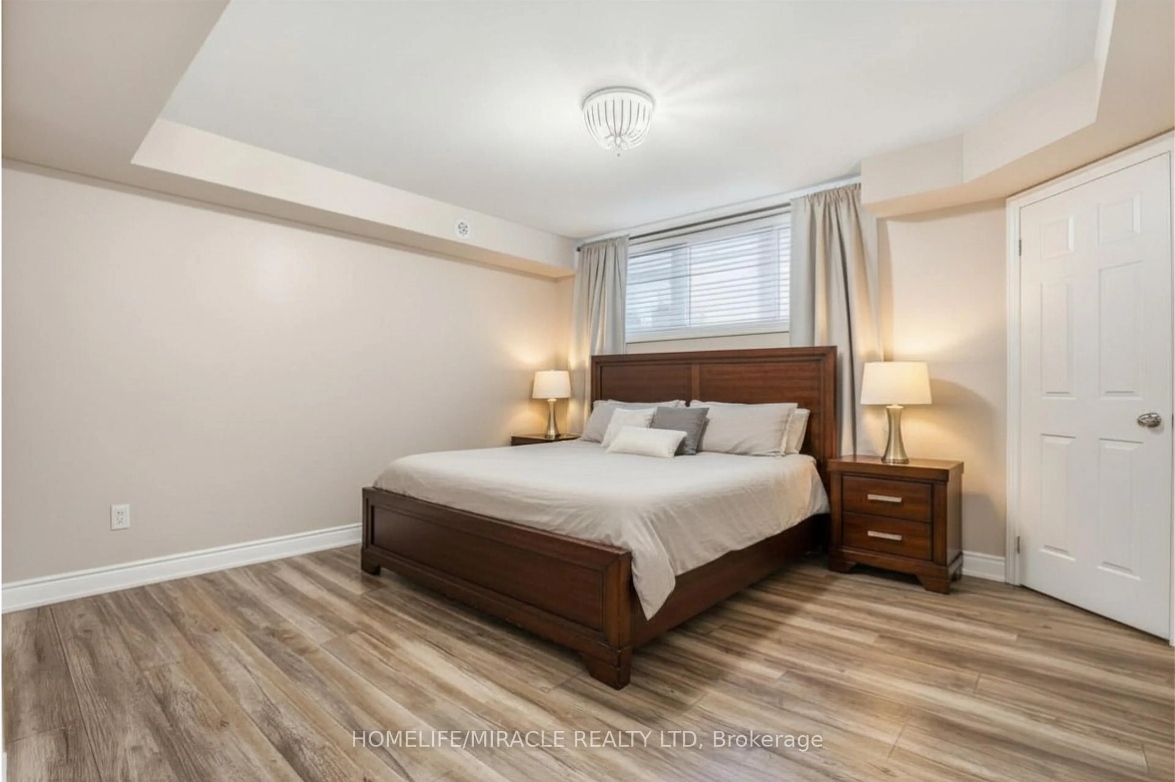 Bedroom with bed, wood/laminate floor for 2420 Baronwood Dr #8-01, Oakville Ontario L6M 0X6
