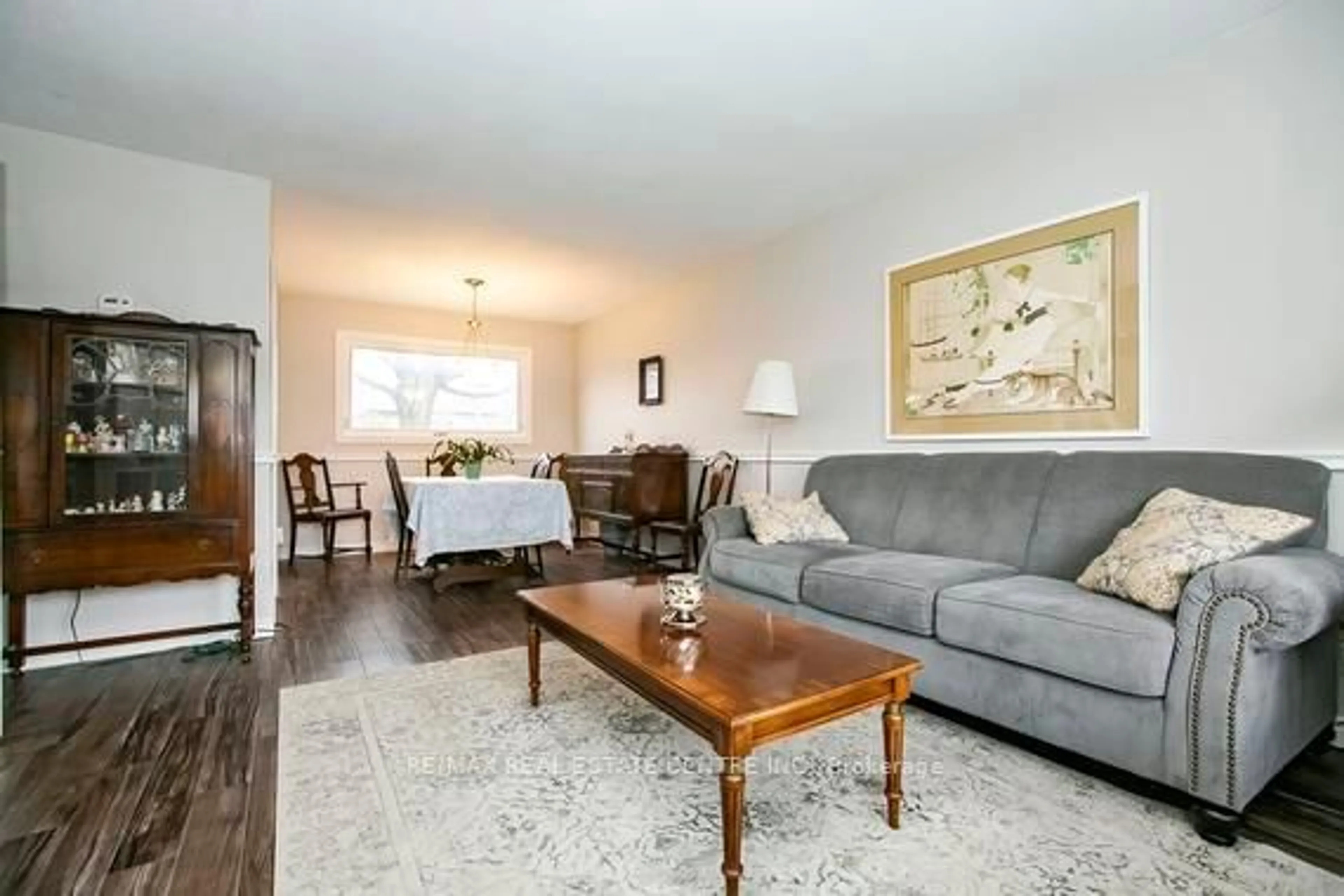 Living room with furniture, wood/laminate floor for 125 Madoc Dr, Brampton Ontario L6V 2A5