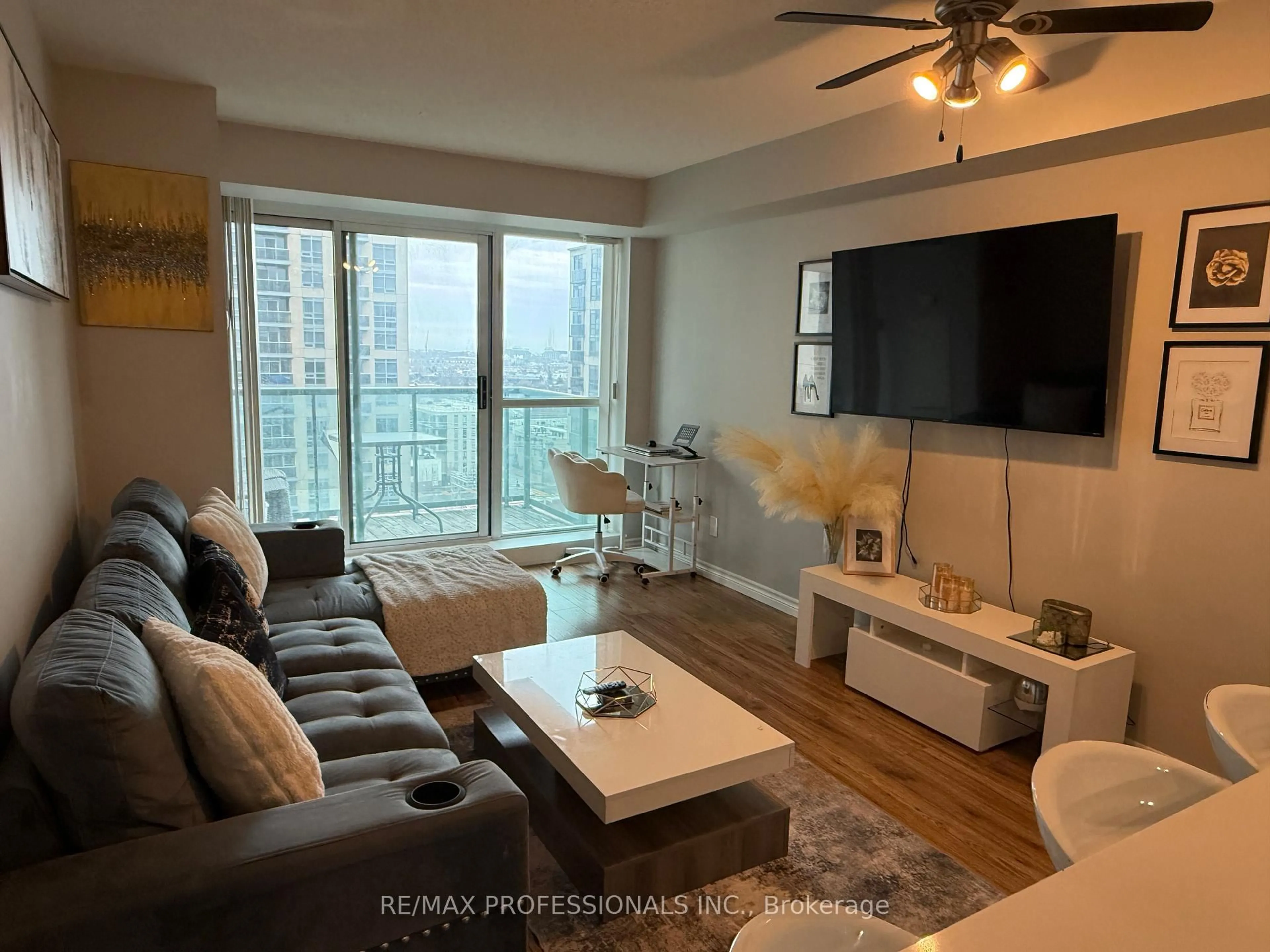 Living room with furniture, wood/laminate floor for 7 Michael Power Pl #1406, Toronto Ontario M9A 0A4