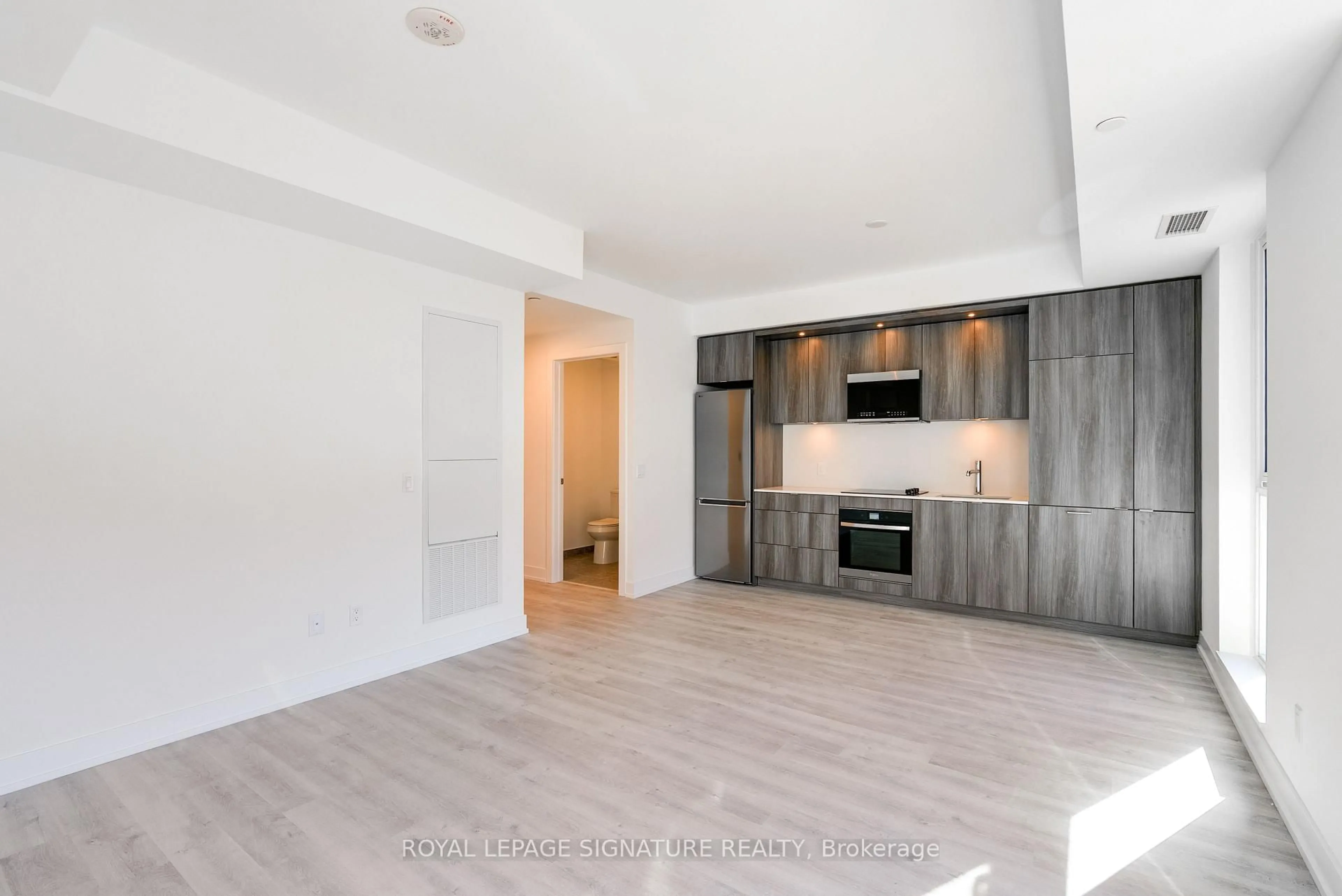Open concept kitchen, wood/laminate floor for 25 Cordova Ave #219, Toronto Ontario M9A 0E5