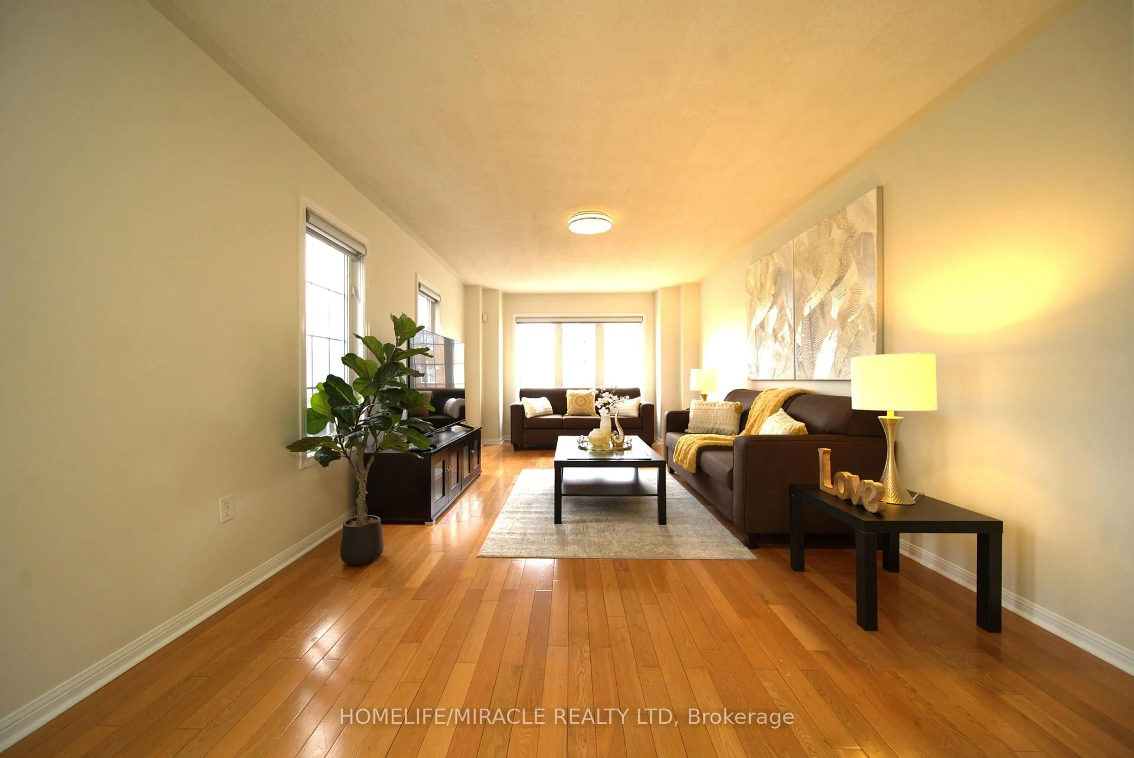 Living room with furniture, wood/laminate floor for 30 ORANGEGROVE Dr, Brampton Ontario L7A 3N4