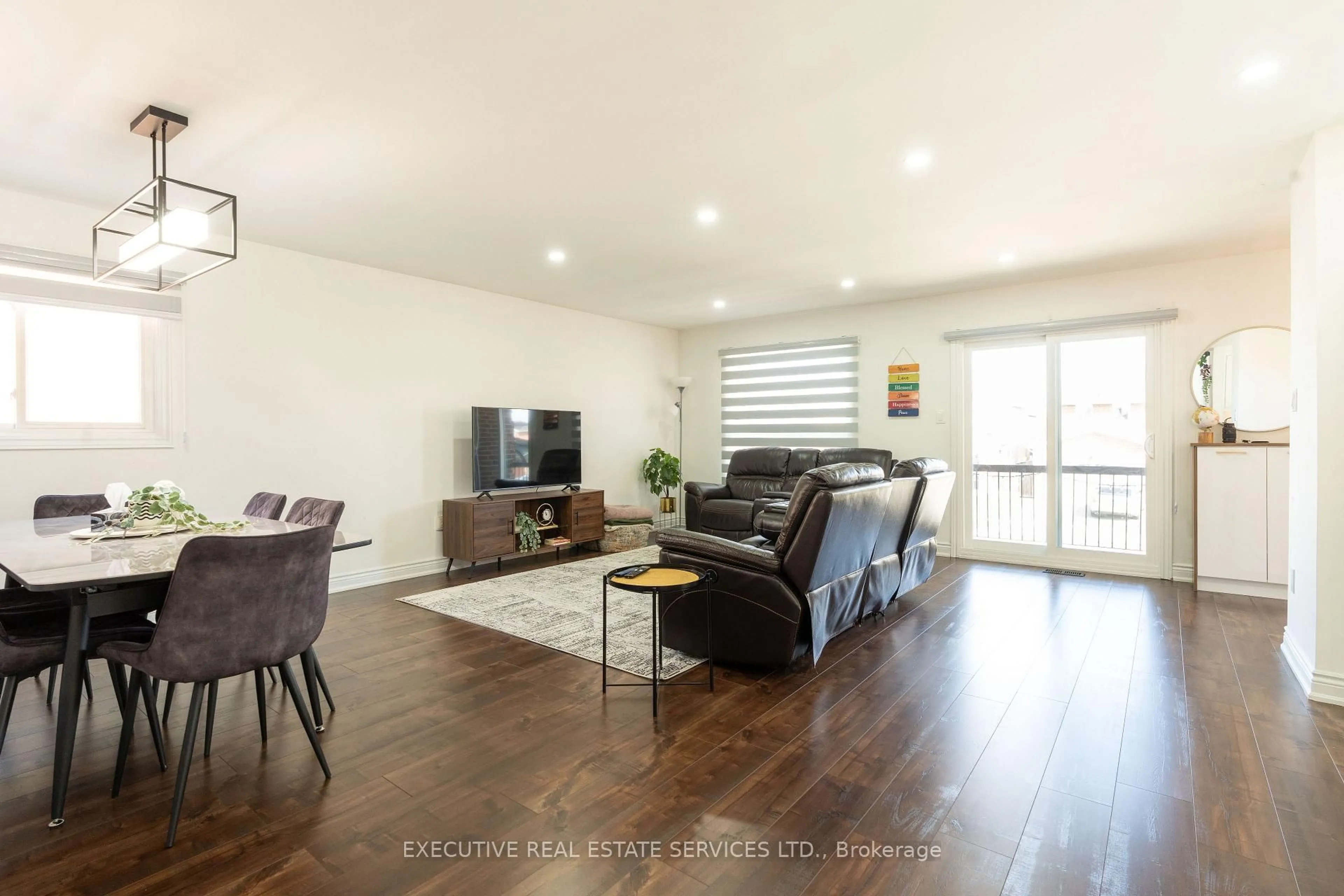 Living room with furniture, wood/laminate floor for 90 HINCHLEY WOOD Grve, Brampton Ontario L6V 3M3
