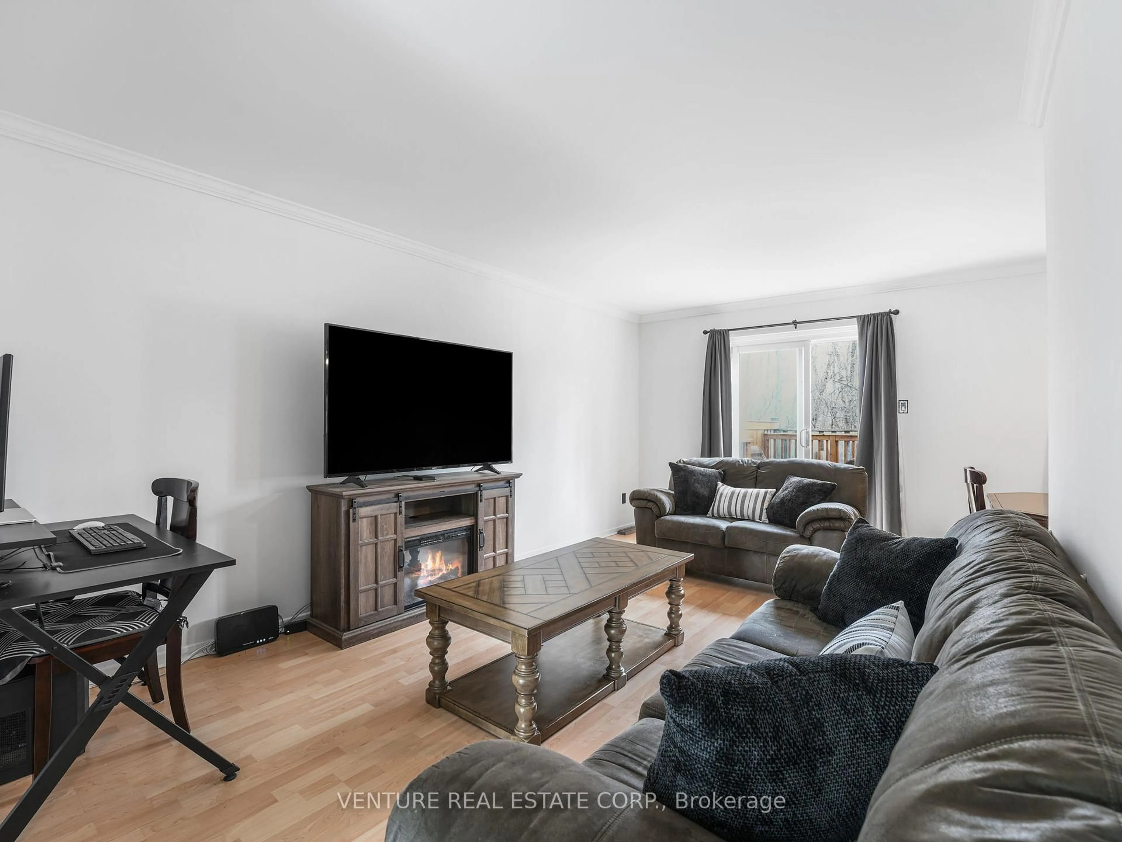 Living room with furniture, wood/laminate floor for 6779 Glen Erin Dr #7, Mississauga Ontario L5N 2C1