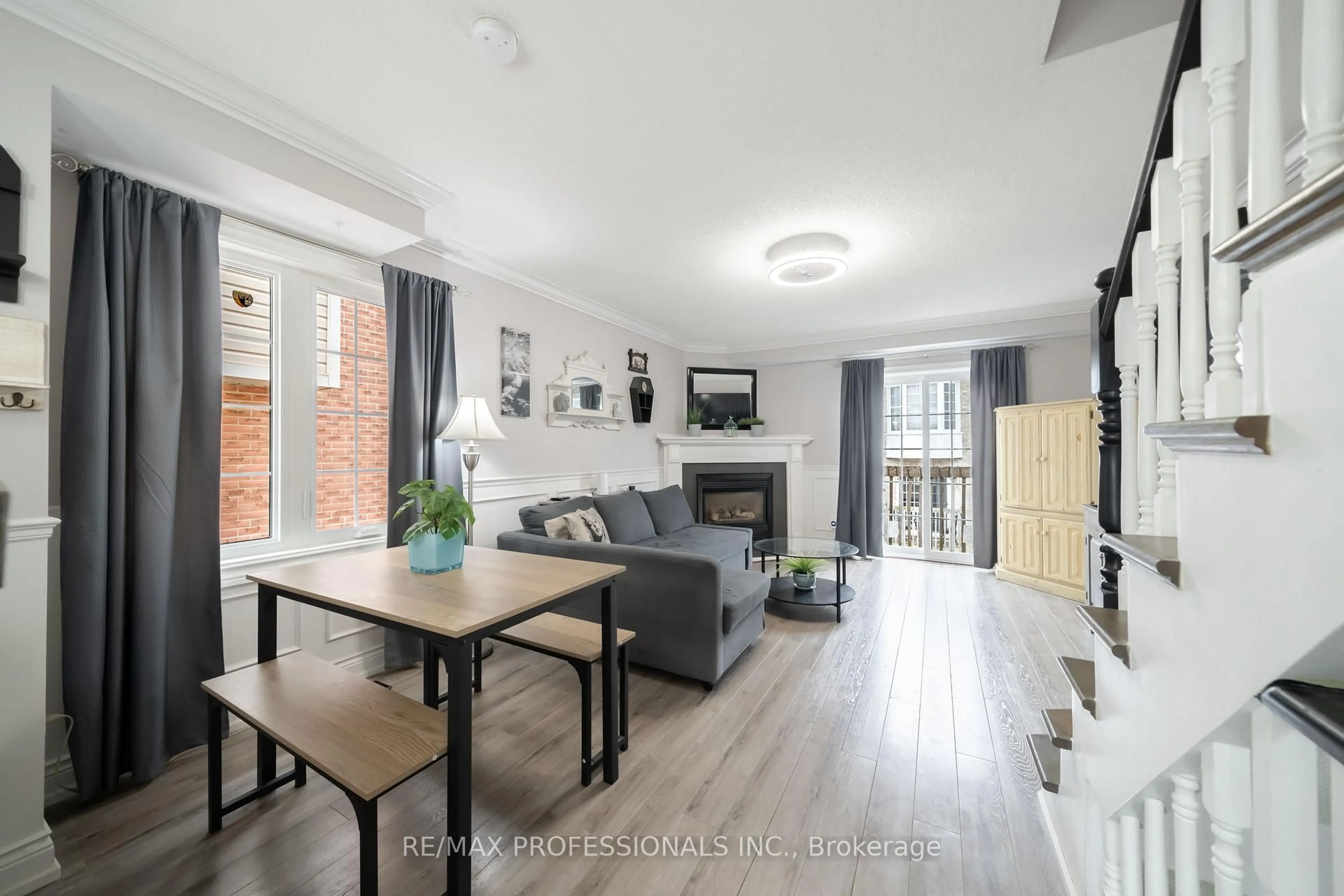 Living room with furniture, wood/laminate floor for 3480 Upper Middle Rd #12, Burlington Ontario L7M 4R8