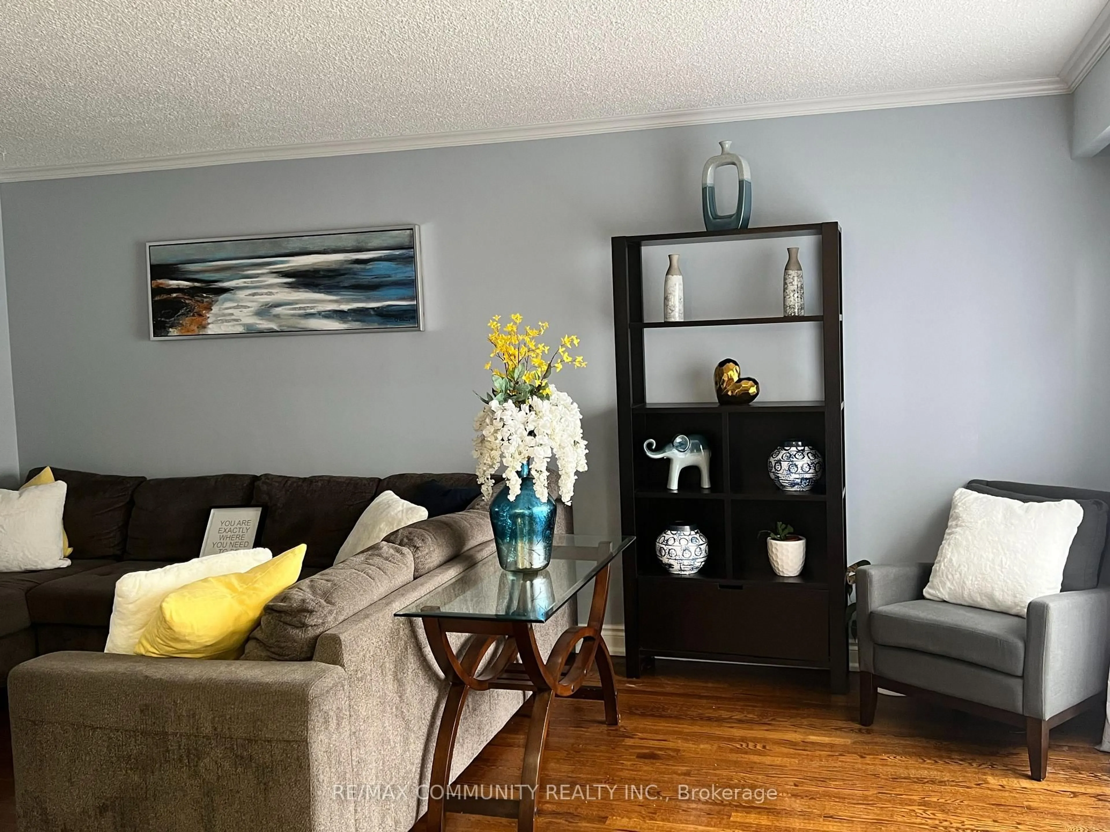 Living room with furniture, wood/laminate floor for 37 Vodden Crt, Brampton Ontario L6V 2V7
