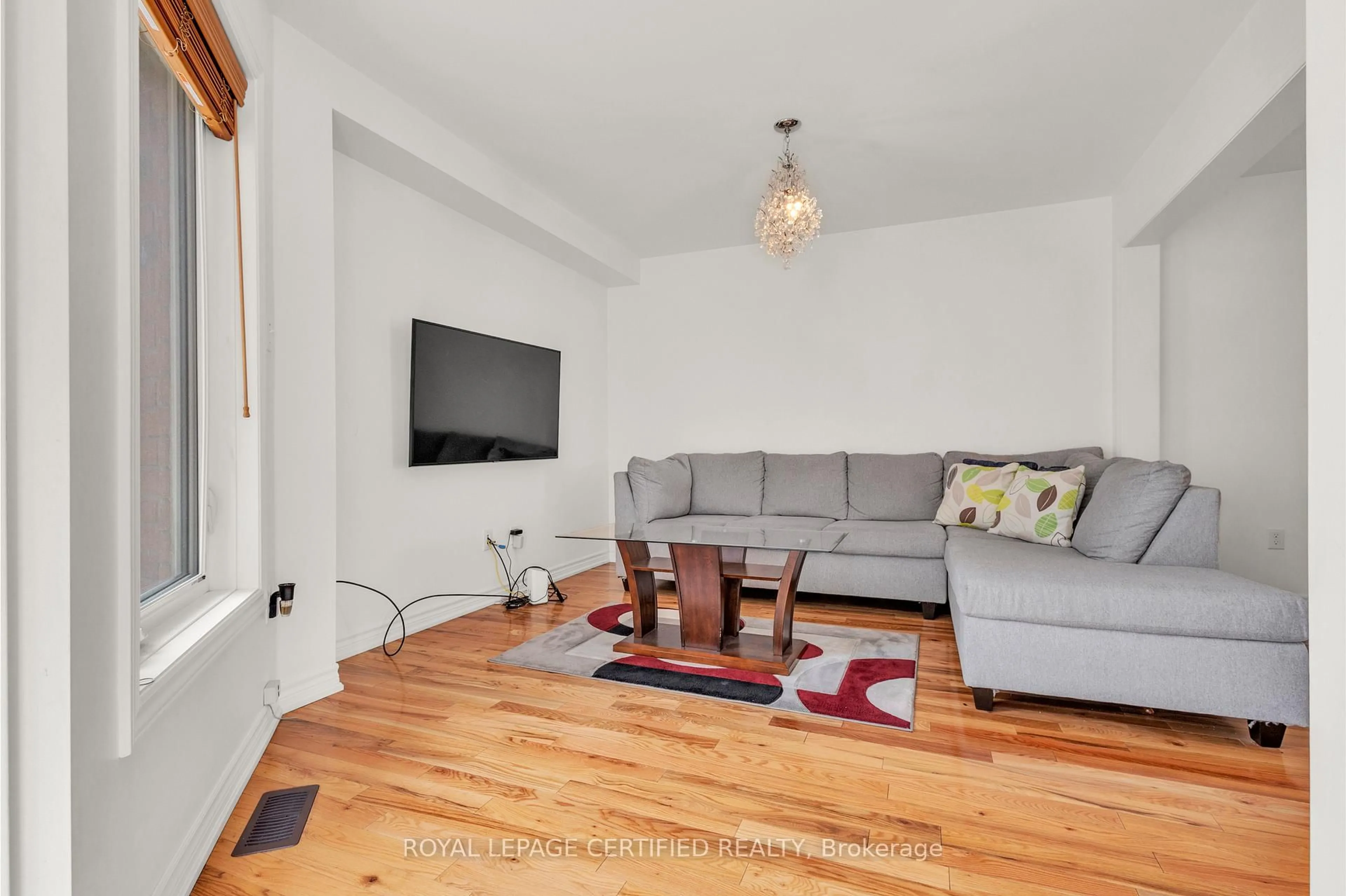 Living room with furniture, wood/laminate floor for 13 Mount Fuji Cres, Brampton Ontario L6R 2L3