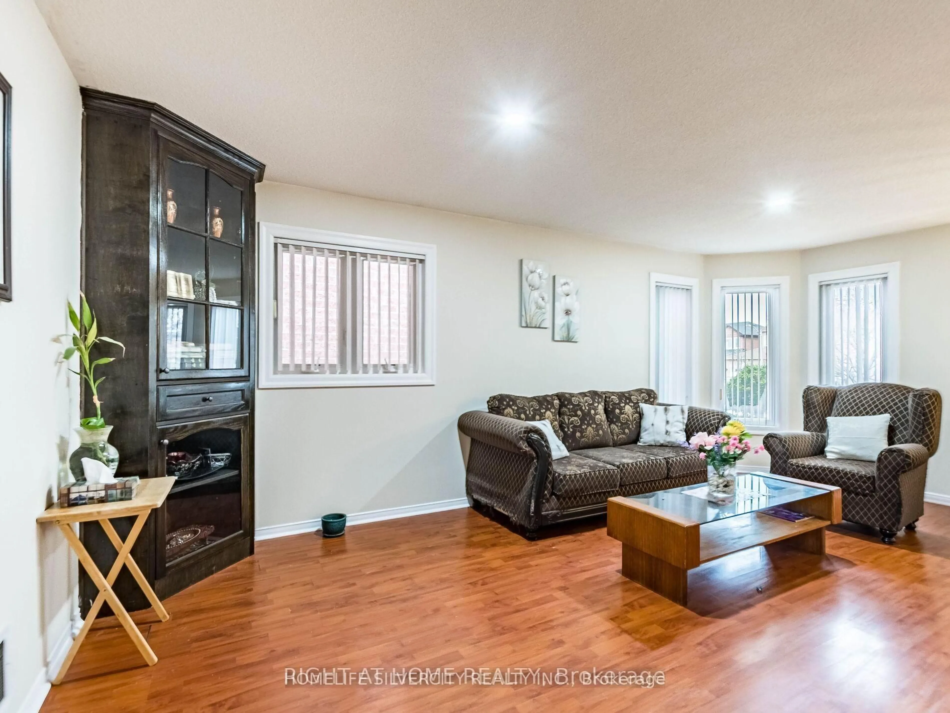 Living room with furniture, wood/laminate floor for 69 Red Maple Dr, Brampton Ontario L6X 4M1