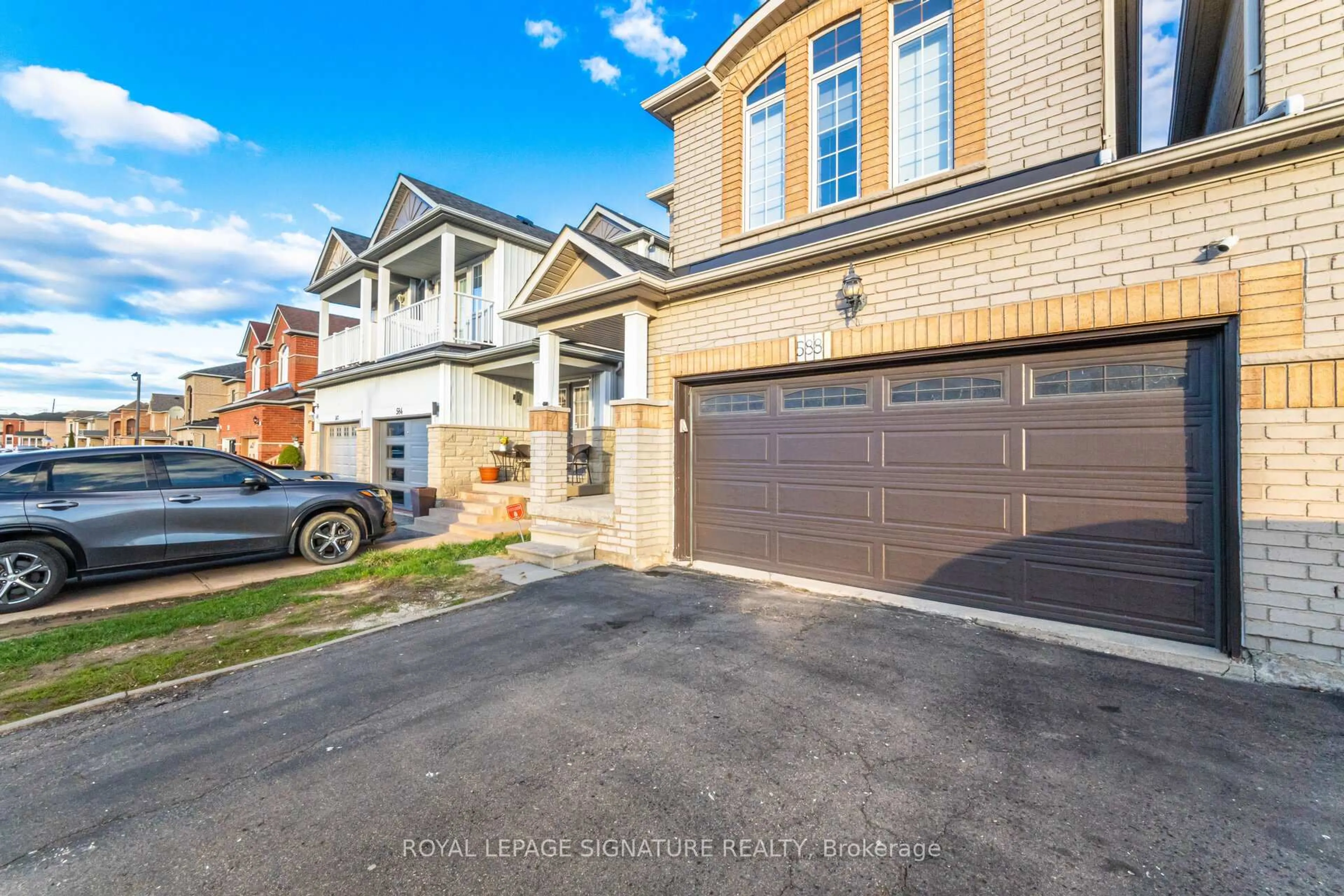 Home with brick exterior material, street for 588 Rossellini Dr, Mississauga Ontario L5W 1M4