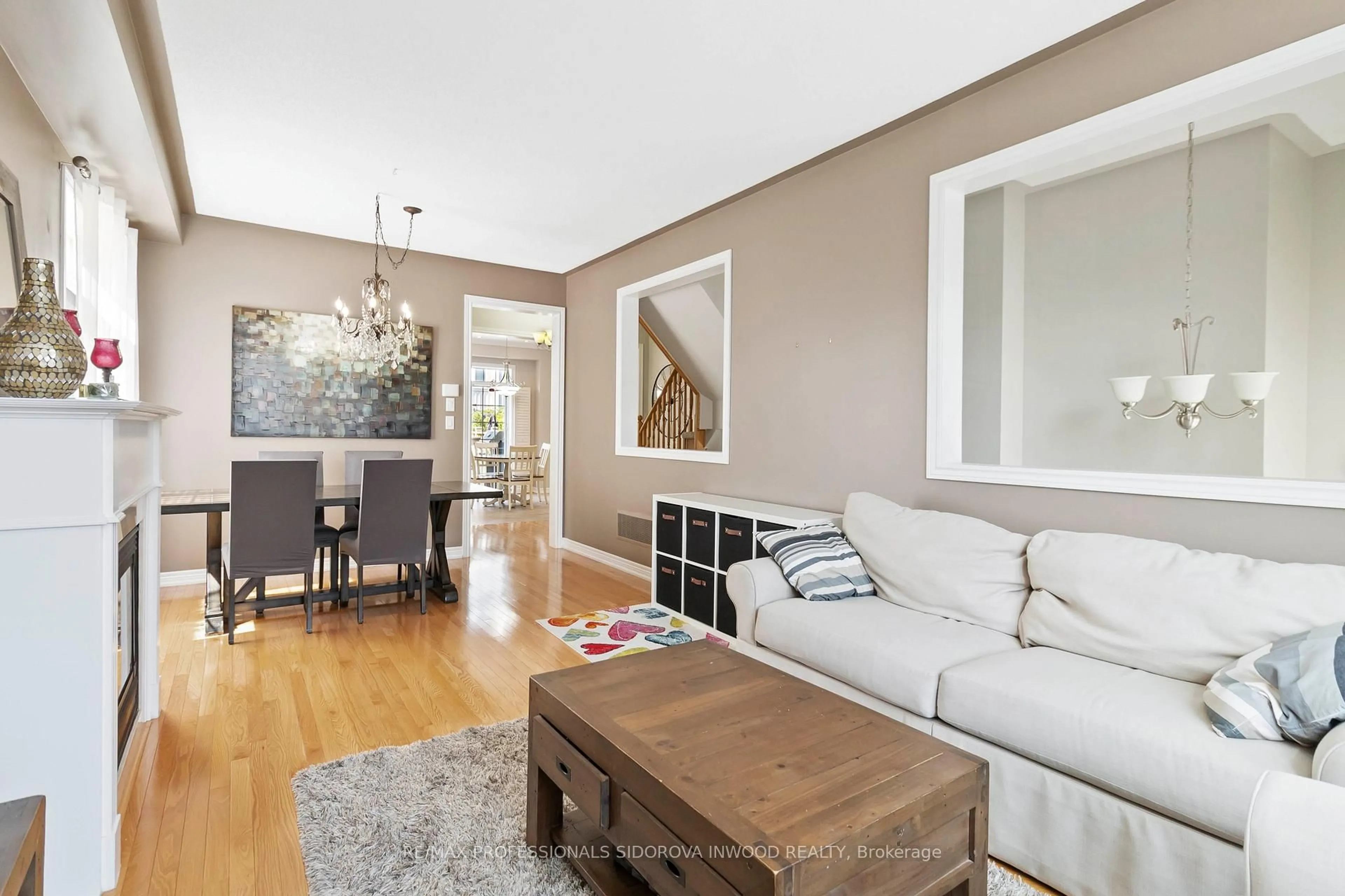 Living room with furniture, wood/laminate floor for 43 Sutcliff Lane, Halton Hills Ontario L7G 0C2