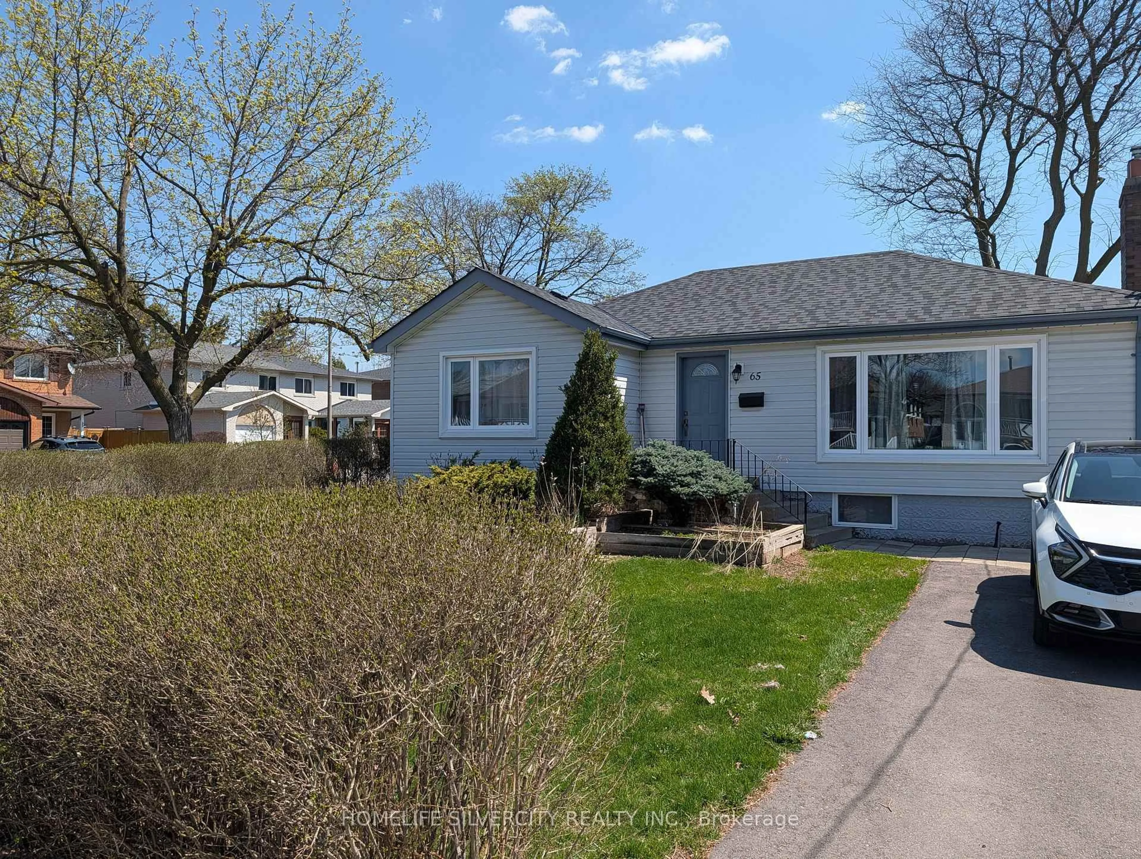 Home with vinyl exterior material, street for 65 English St, Brampton Ontario L6X 1L5